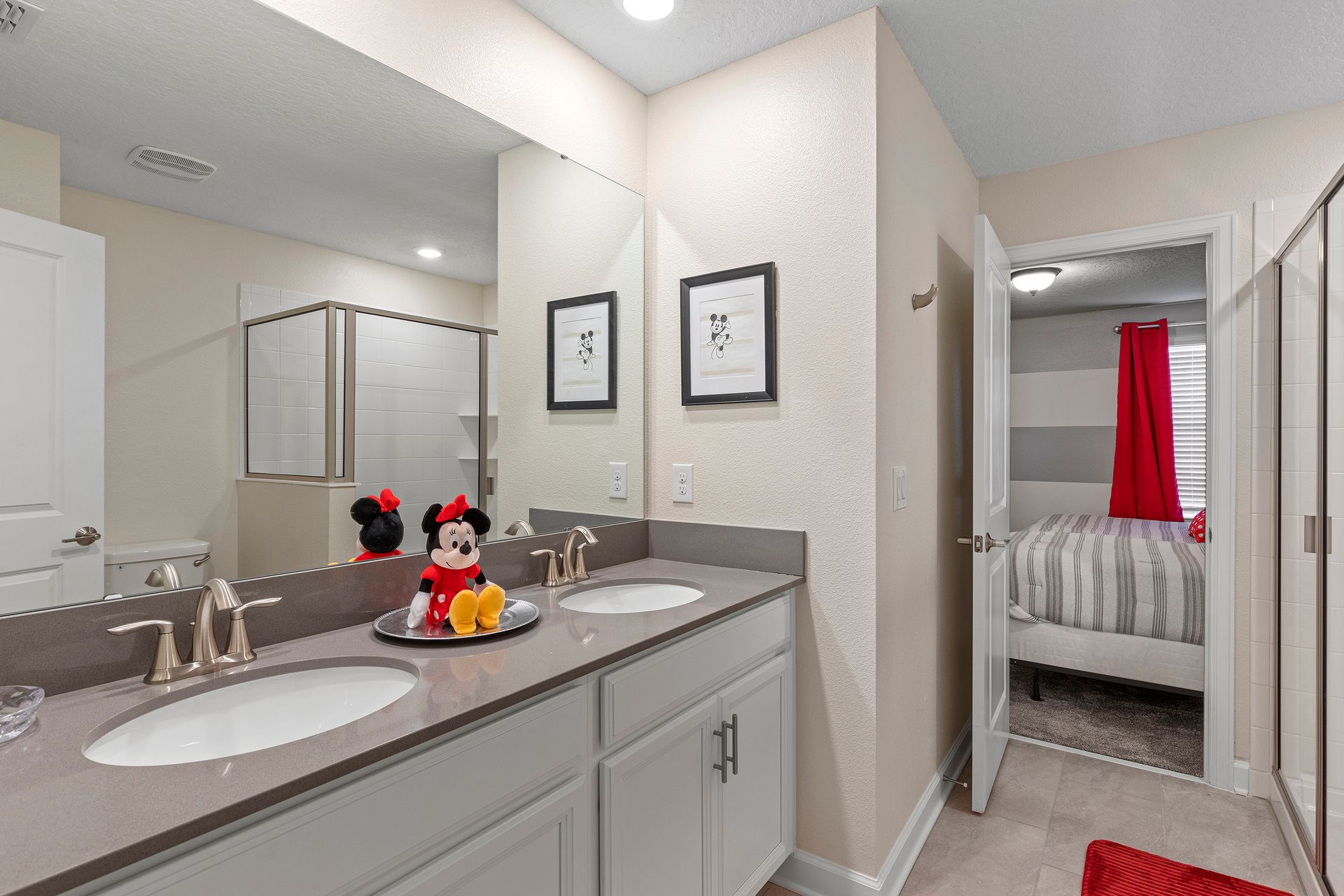 Charming bathroom with dual sinks, Disney decor, and a bright, playful touch.