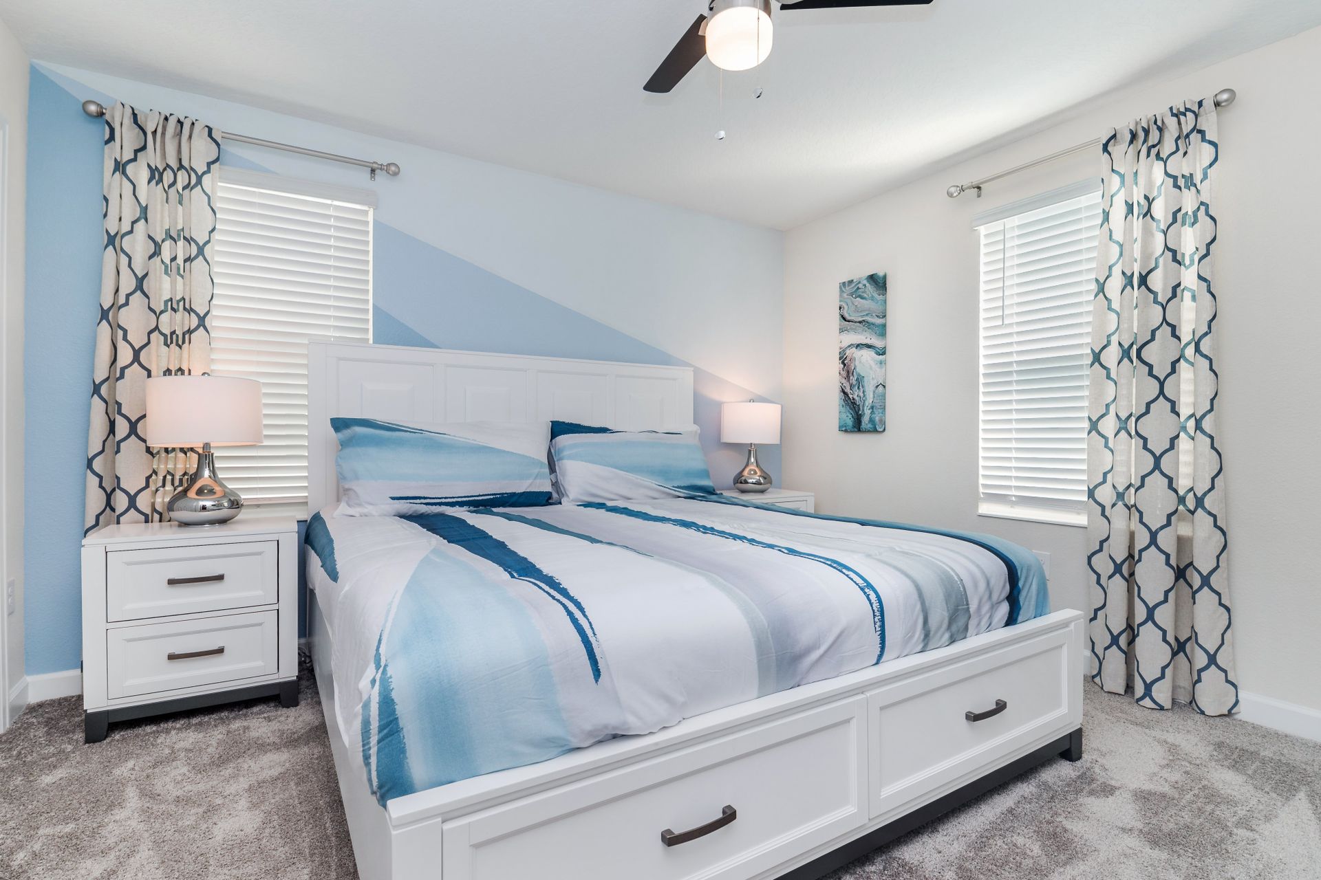 Coastal-themed bedroom with soft blues, modern decor, and a serene atmosphere.