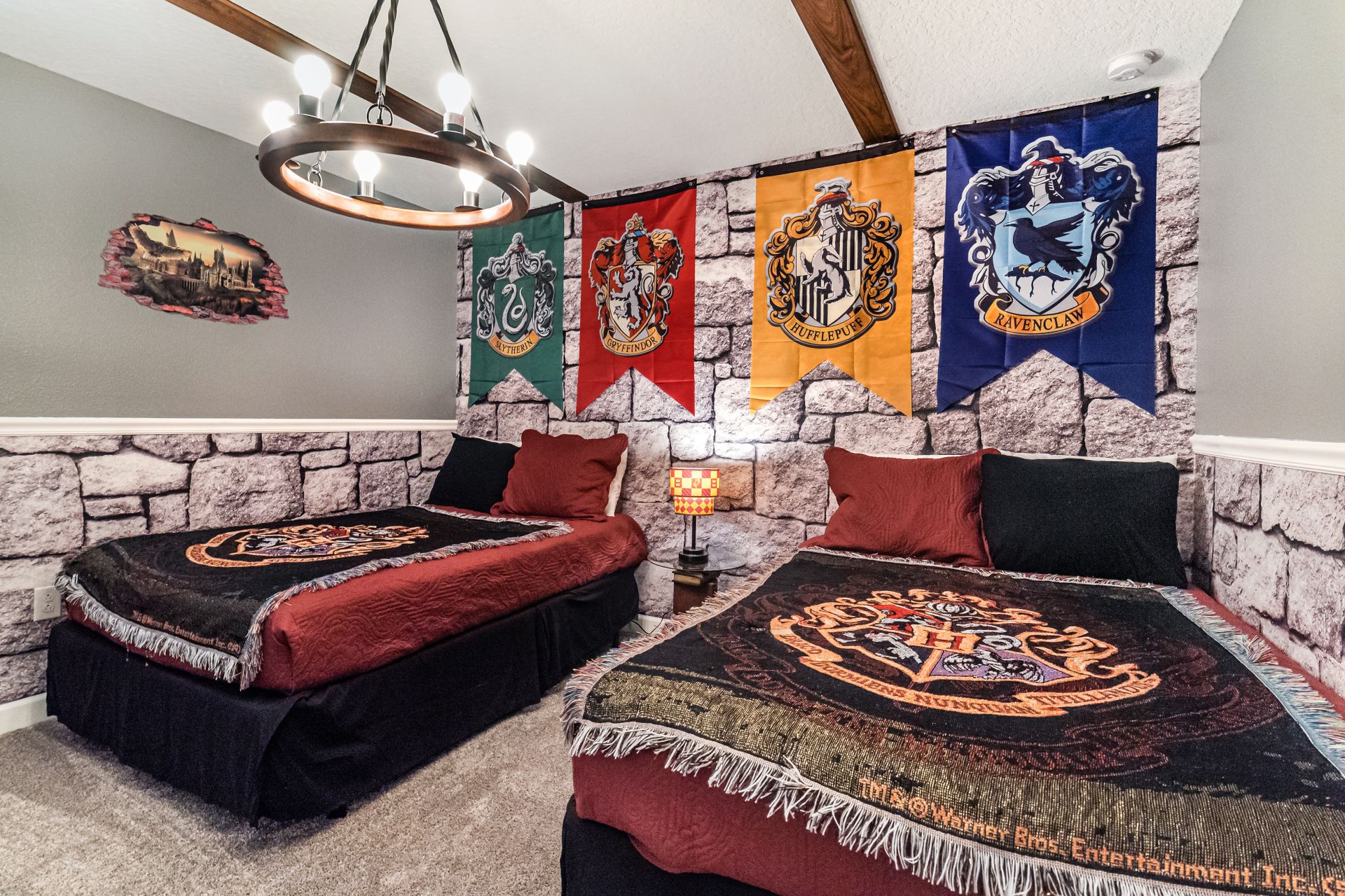 Wizard-themed room with house banners, stone walls, and magical decor details.