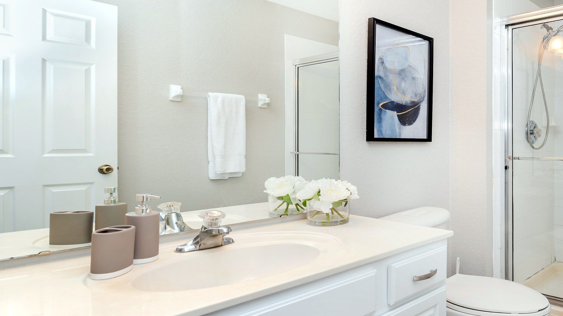 Elegant, minimalist bathroom with flowers and artistic decor.