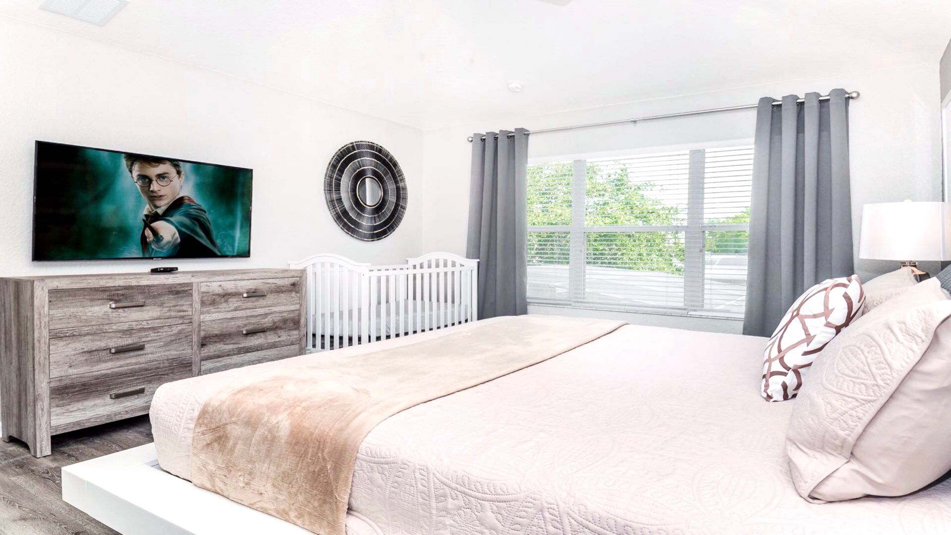 Serene bedroom with a geometric headboard and cozy, neutral tones.