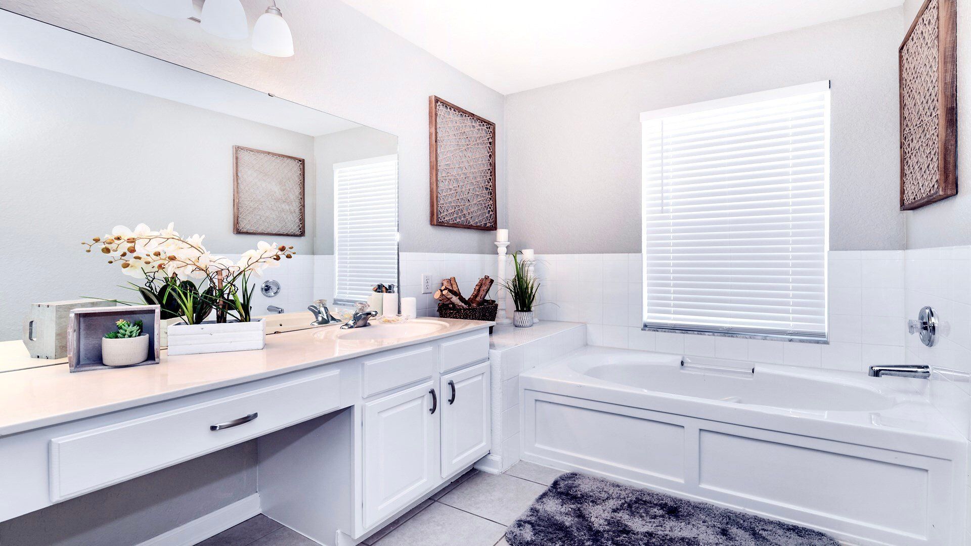 Bright bathroom oasis with natural accents and spacious white vanity.