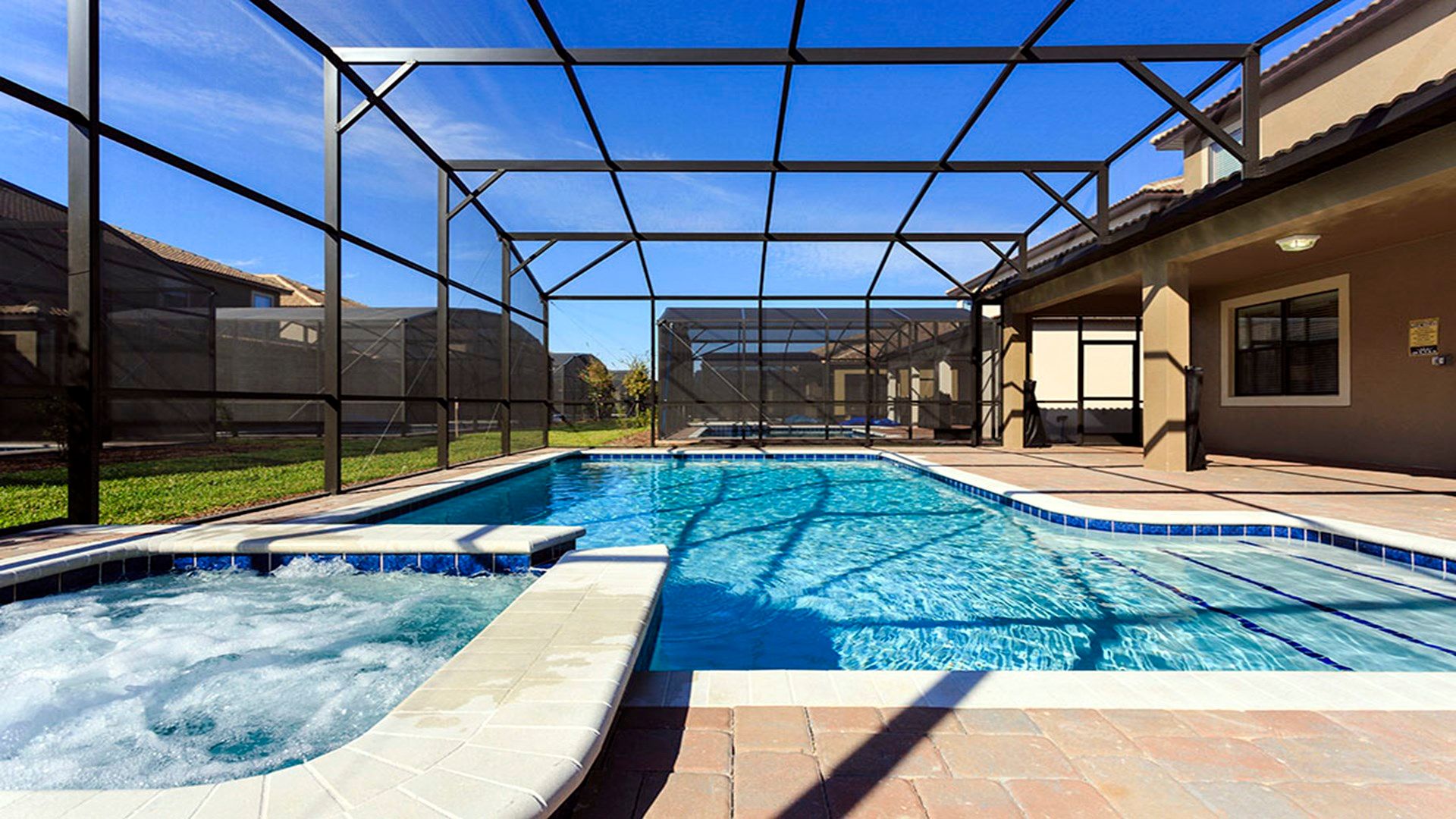 Screened-in spa and pool area, offering a private retreat