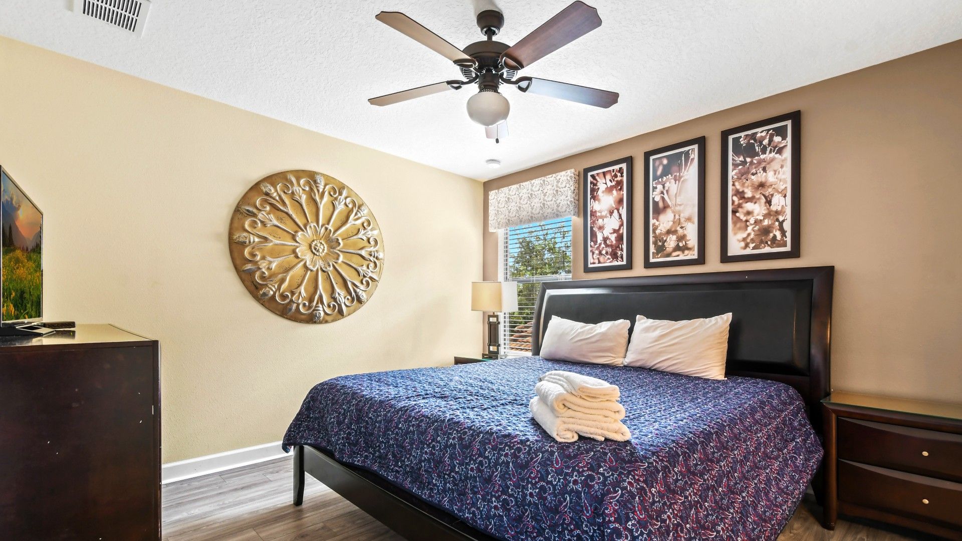 A bedroom with a luxurious king-sized bed complemented by a TV