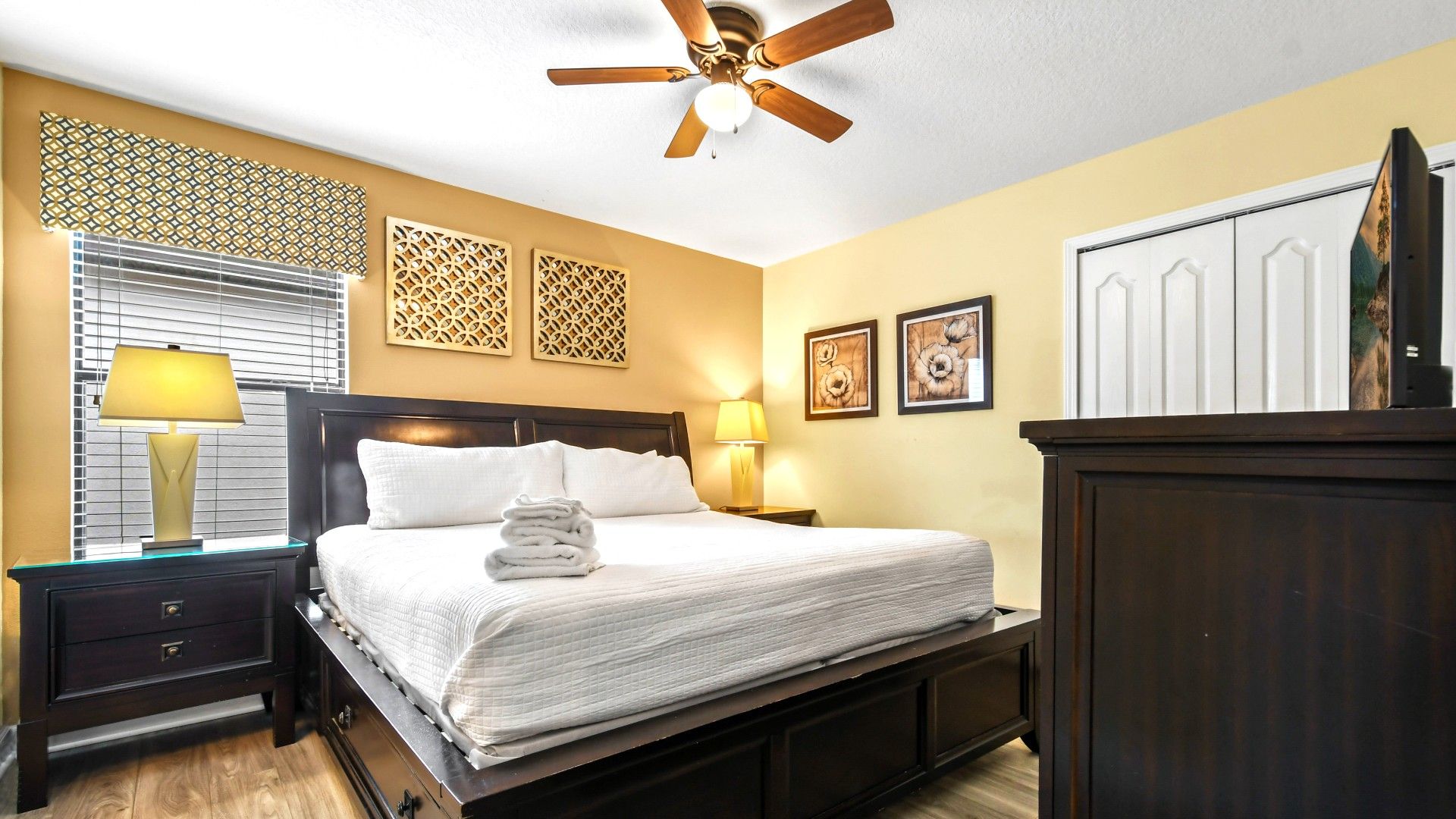 A bedroom with a luxurious king-sized bed complemented by a TV