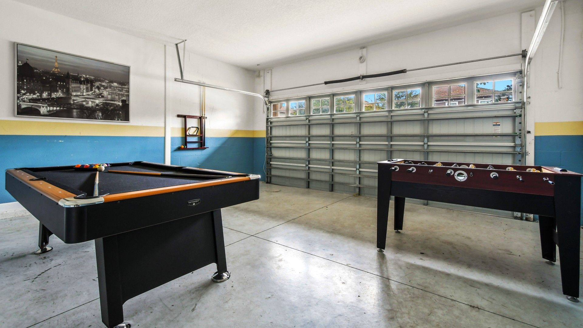 Game room featuring both foosball and pool tables