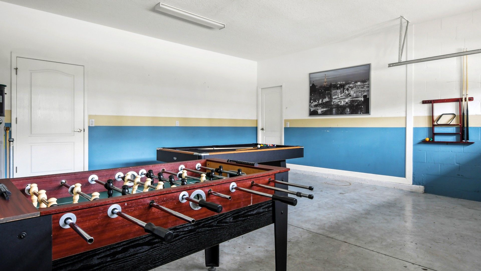 Game room featuring both foosball and pool tables