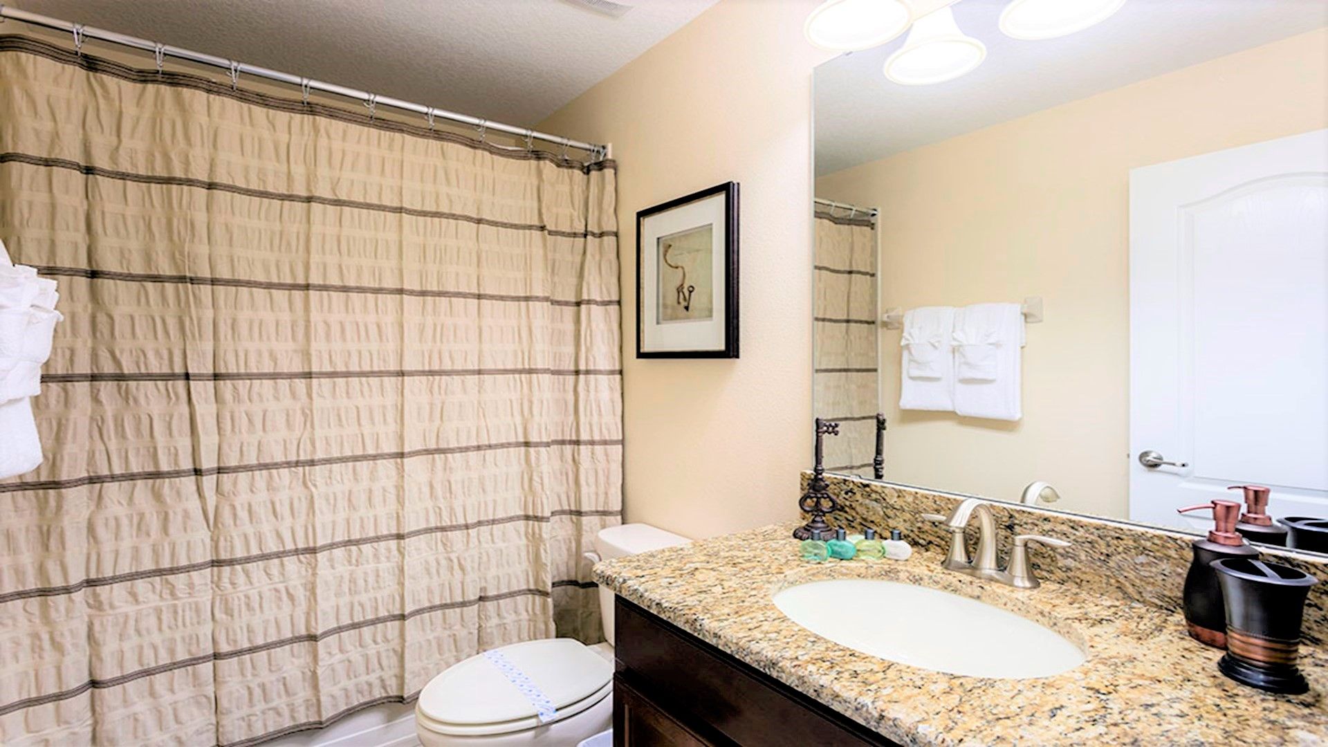A full bathroom, complete with modern fixtures, a spacious vanity.