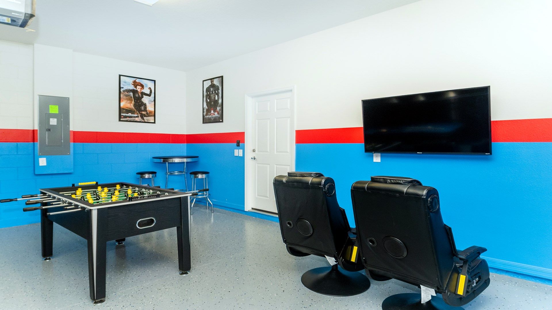The game room is stylishly furnished with pool table and foosball table