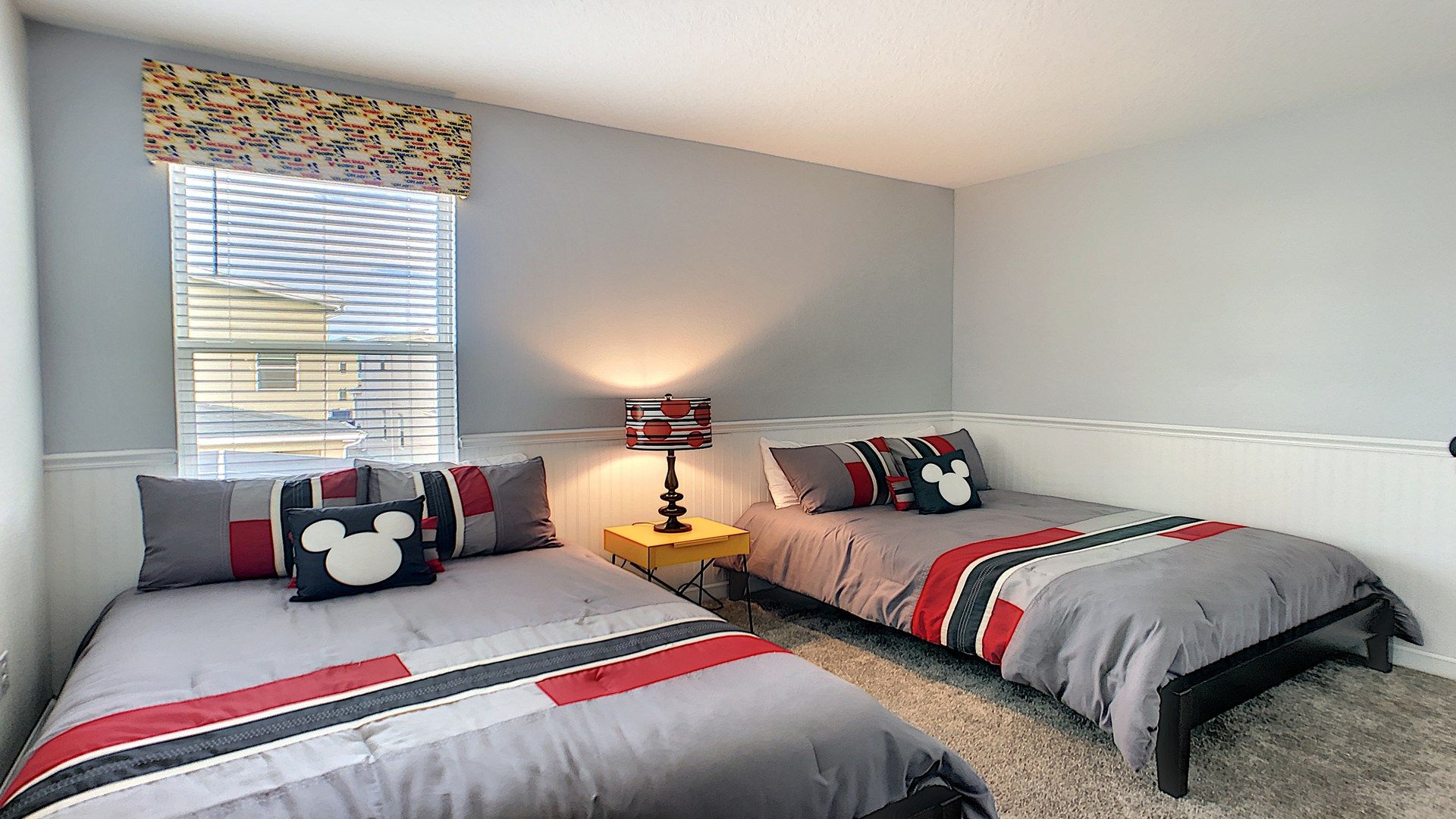 Cozy twin-bed room with Disney-inspired decor, perfect for a fun and relaxing stay.