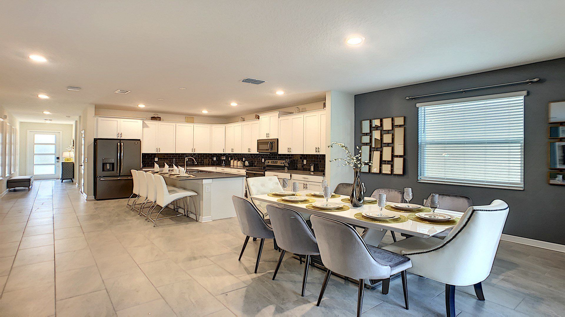 Dinner party ready! This kitchen's got stainless steel shine, granite counters & a table for eight. Breakfast bar for morning coffee chats!