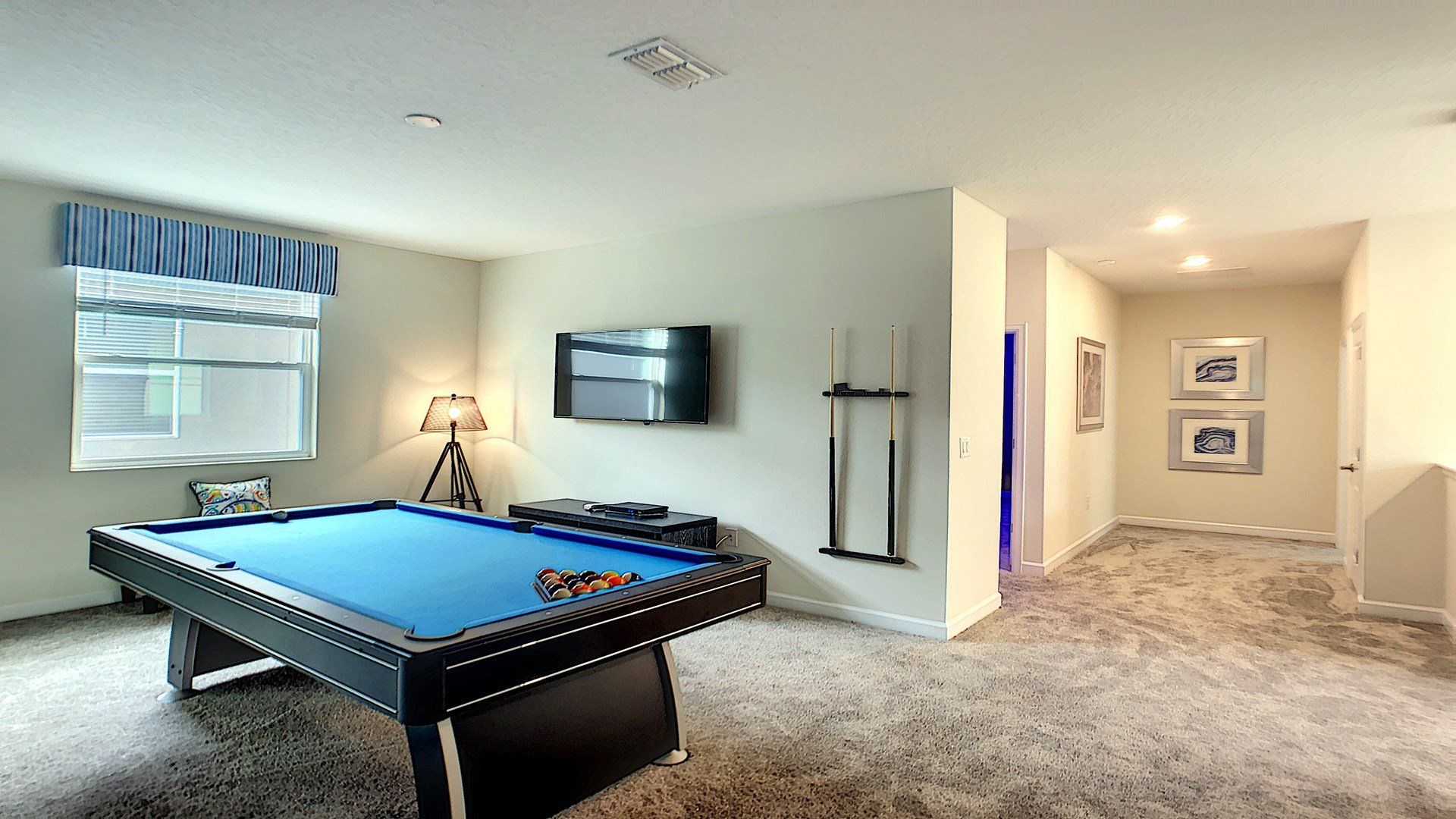 Stylish game room with a pool table, TV, and cozy seating for endless entertainment.