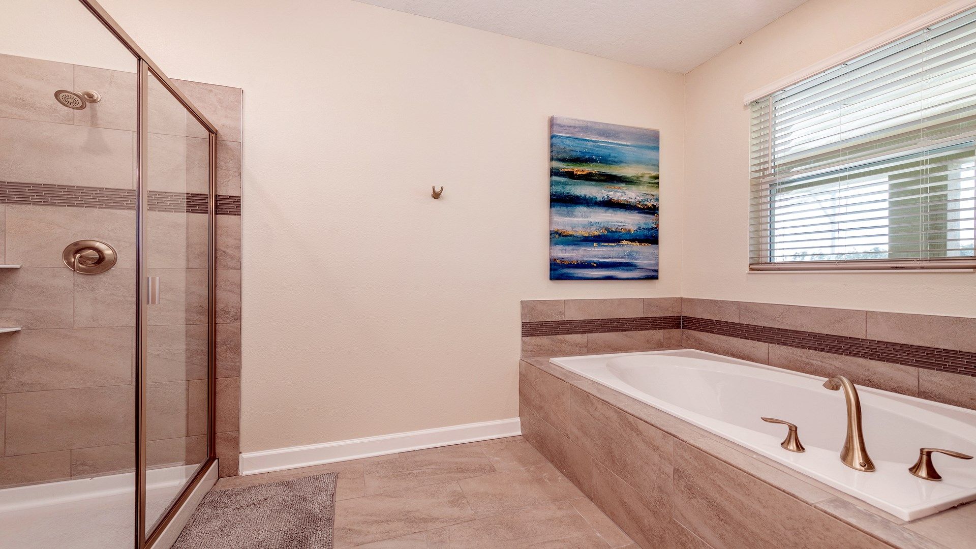 Spacious bathroom featuring a glass shower and soaking tub with tile accents.
