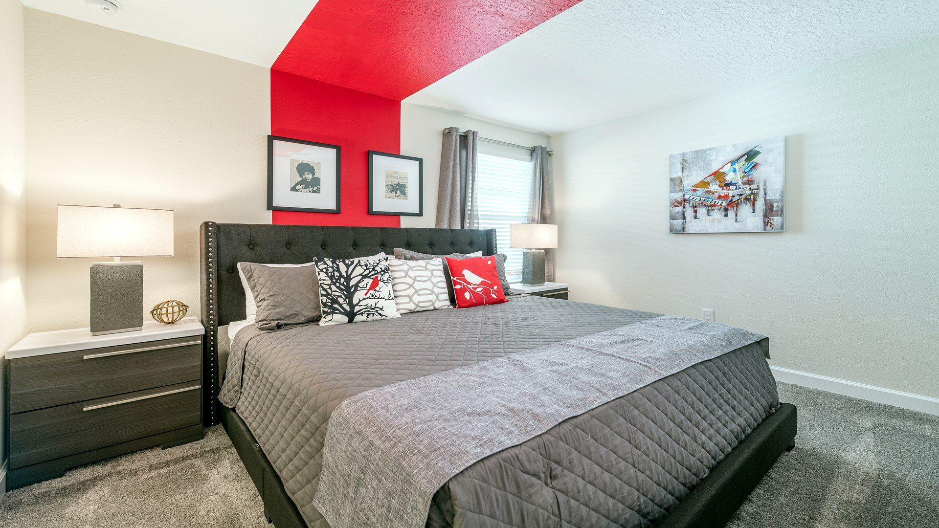Vibrant bedroom with a striking red accent ceiling and stylish modern decor.