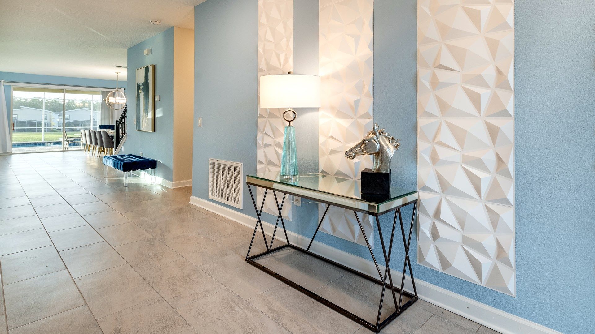 Sleek entryway with geometric wall decor and stylish accents creating a modern vibe.