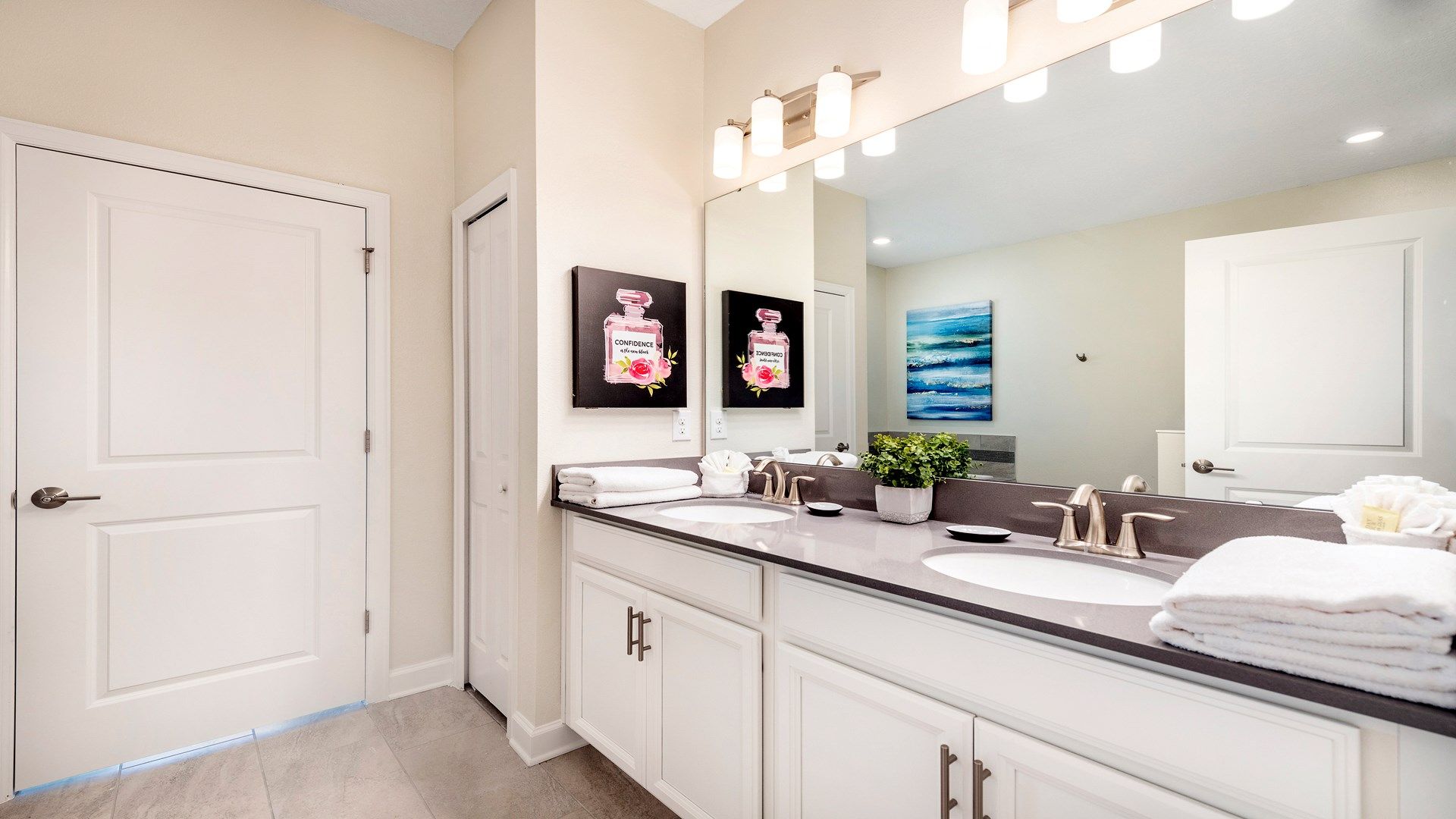 Inviting bathroom with inspirational art, serene color palette, and modern lighting.