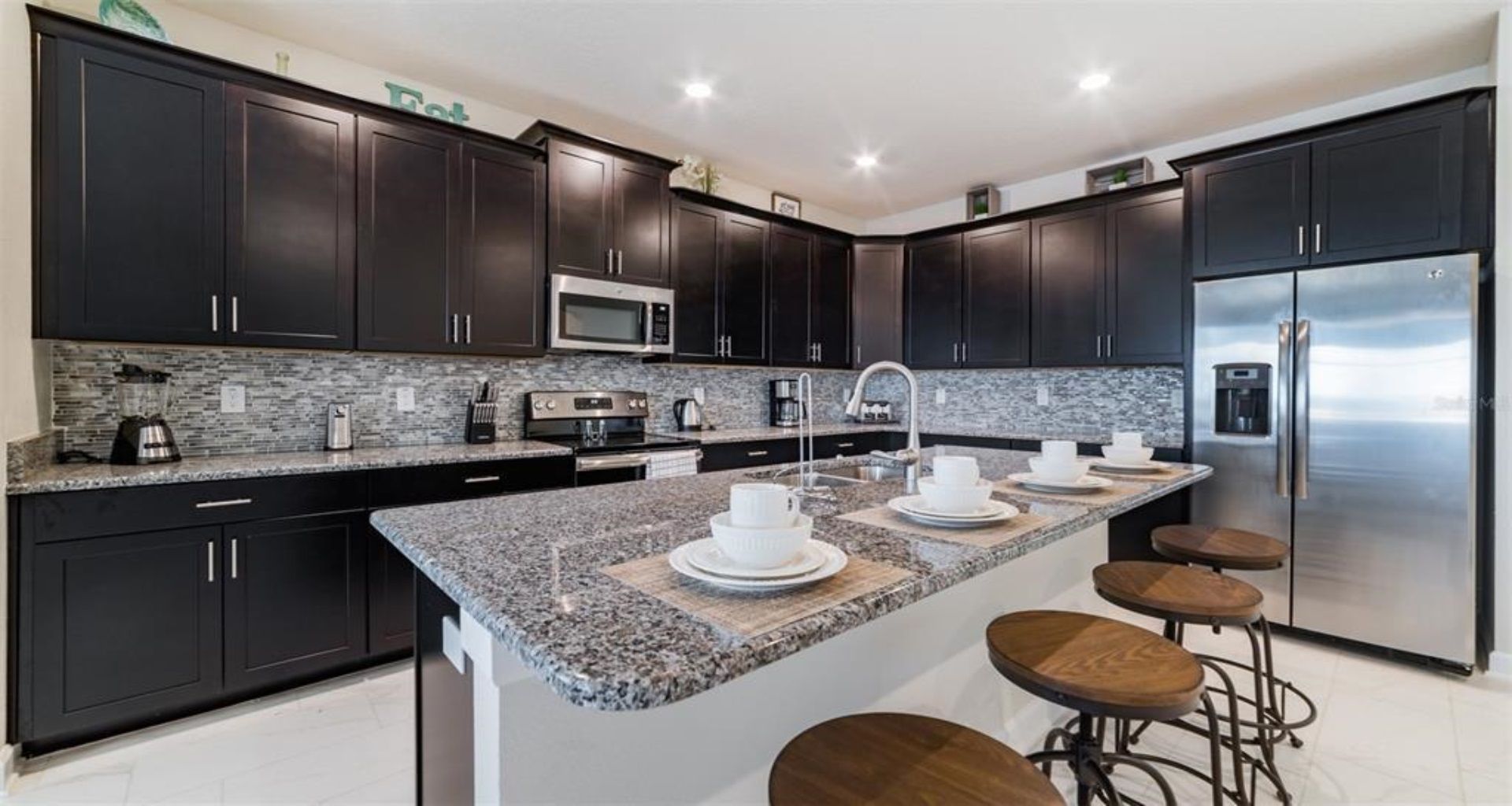 Spacious gourmet kitchen with large island, bar seating, and premium finishes throughout.