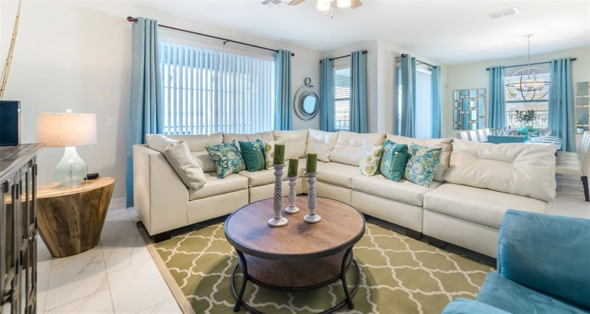 Bright and inviting living space with a large sectional, vibrant accents, and open layout.