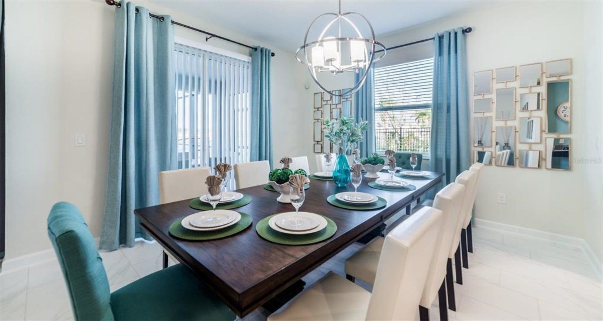 Elegant dining room with seating for eight, modern chandelier, and stylish decor.