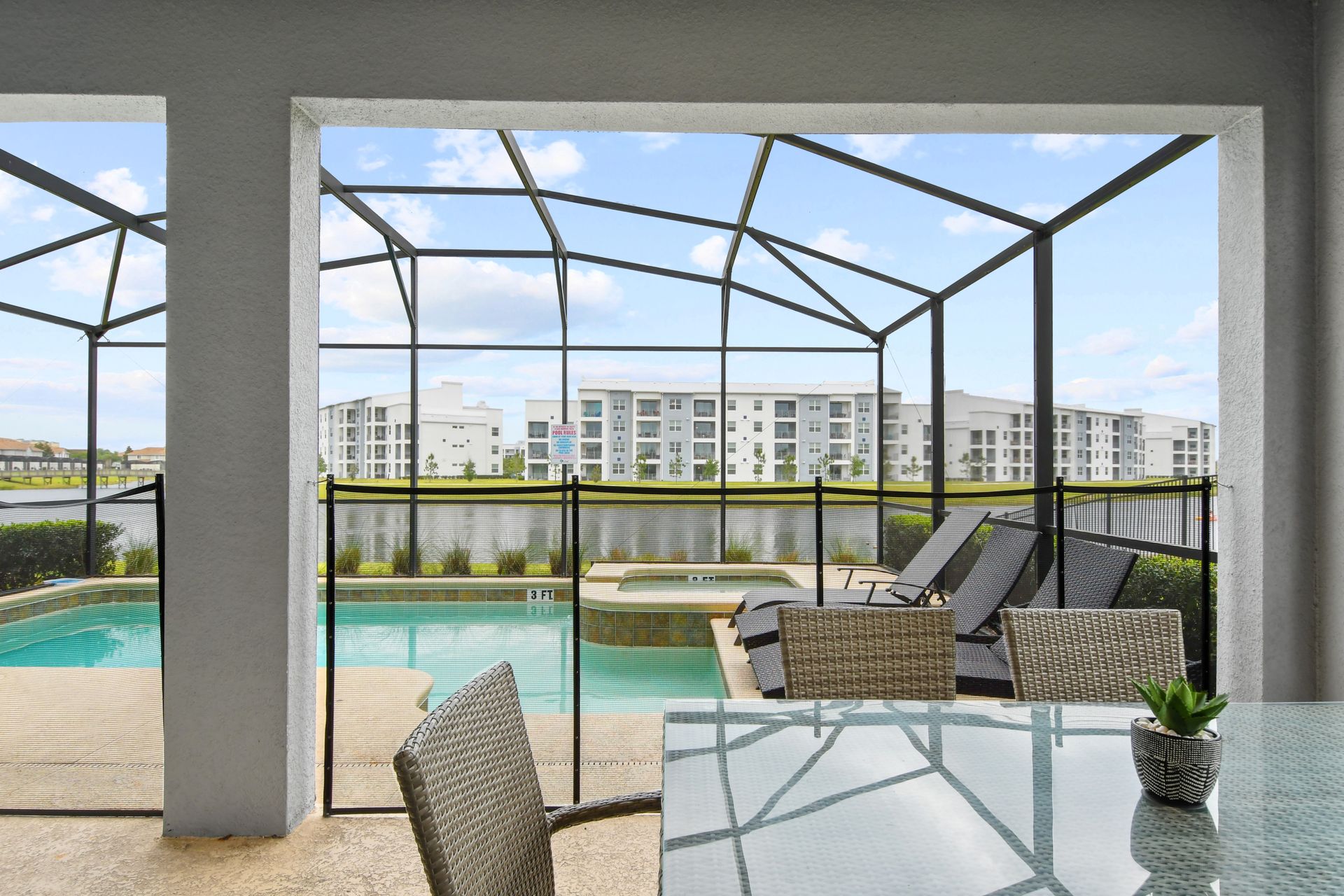 Dine poolside with serene lake views from your private screened-in patio retreat.