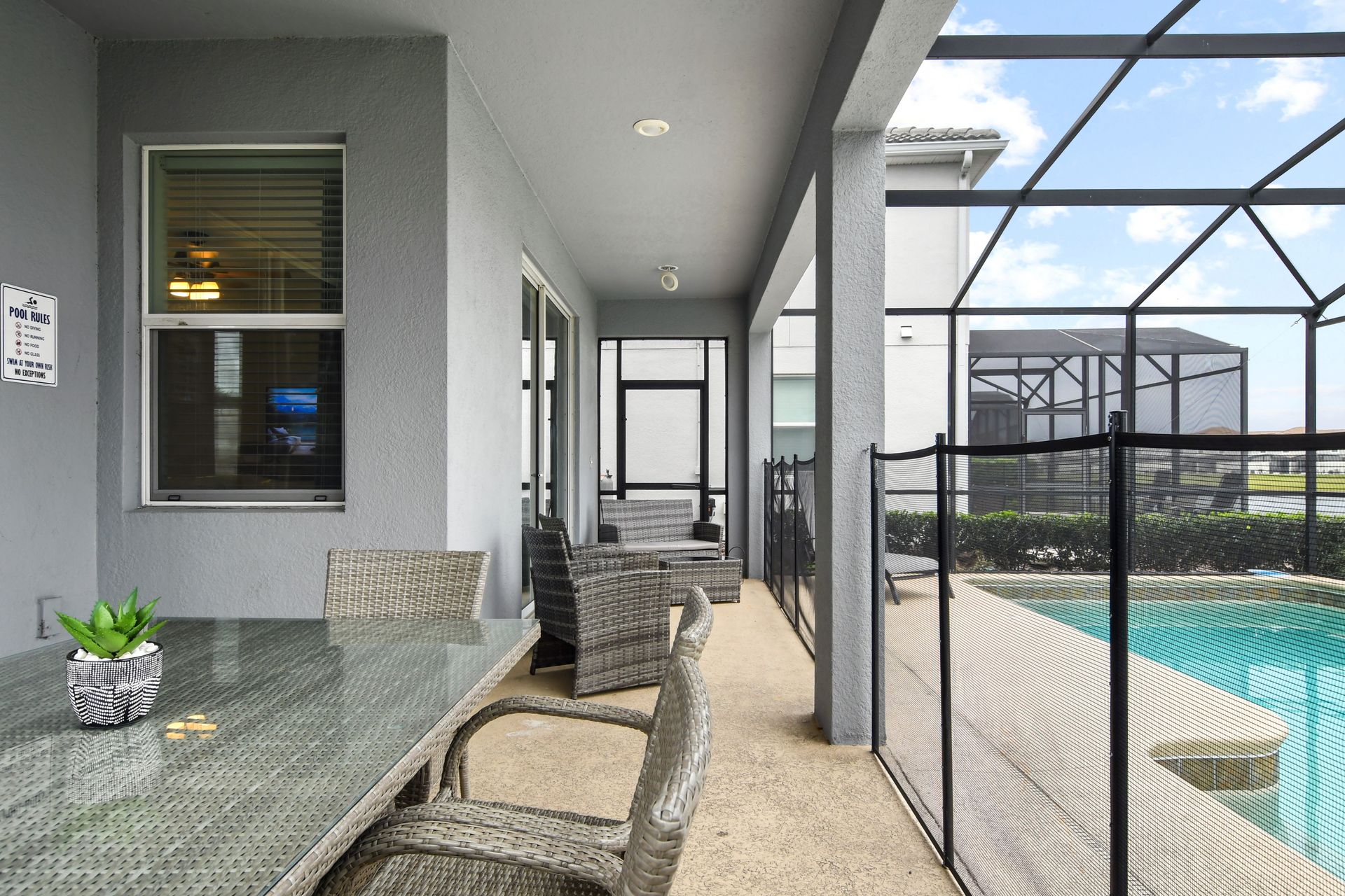 Relax on the shaded patio just steps away from your private screened-in pool.