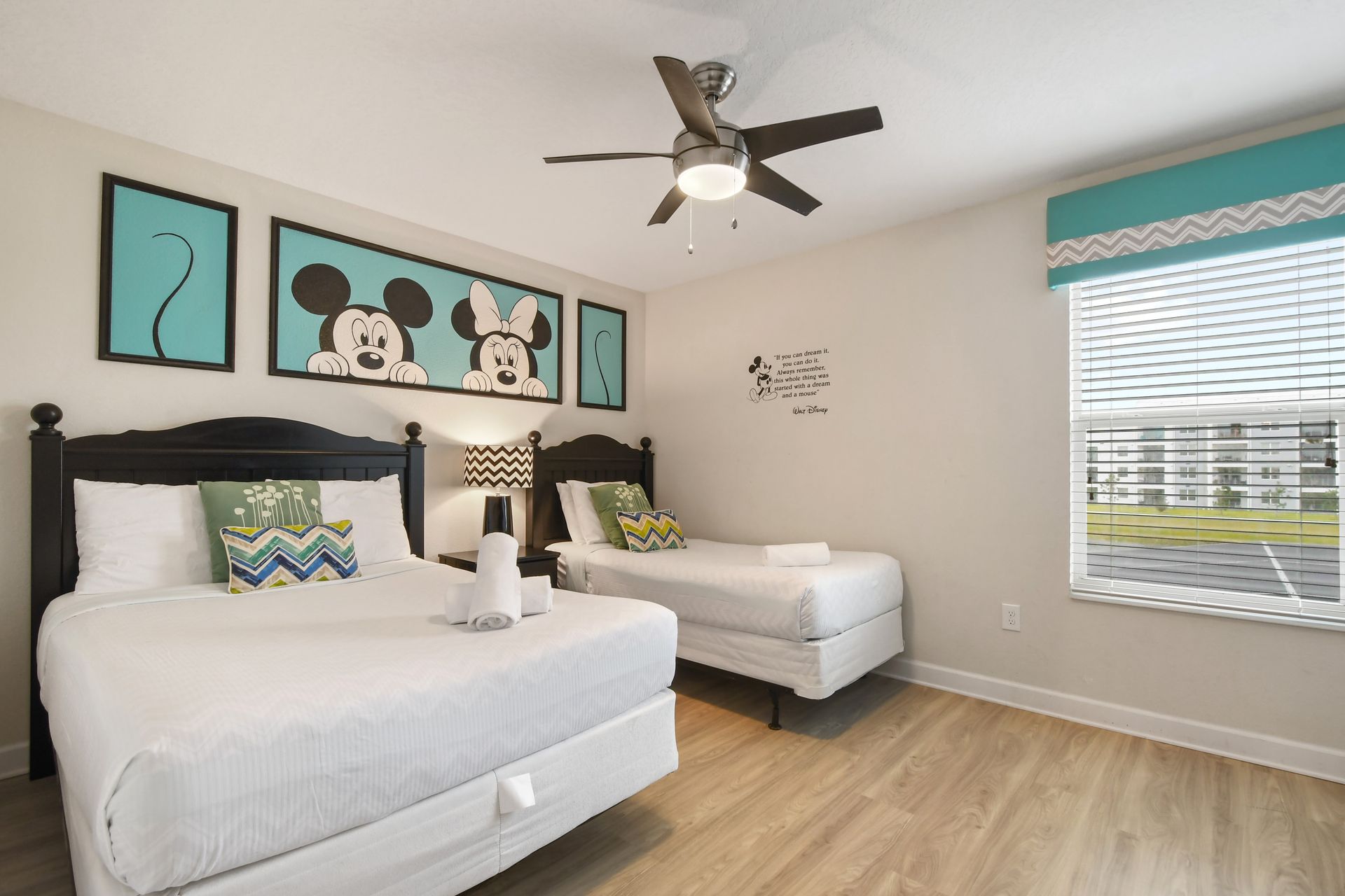 Fun and family-friendly bedroom with twin beds and cheerful character-themed decor.