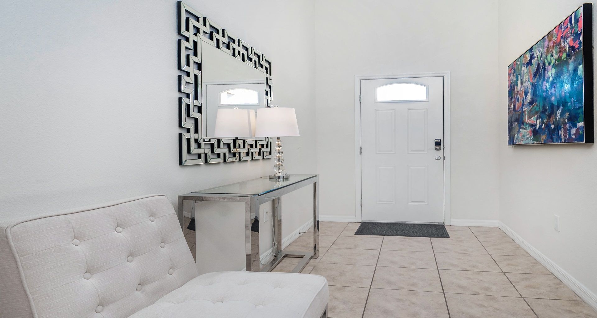 Elegant entryway with modern mirror accents and a welcoming contemporary style.
