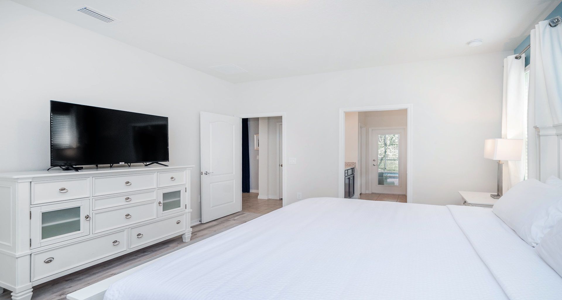 Spacious king suite with smart TV, ensuite bath, and private outdoor access.