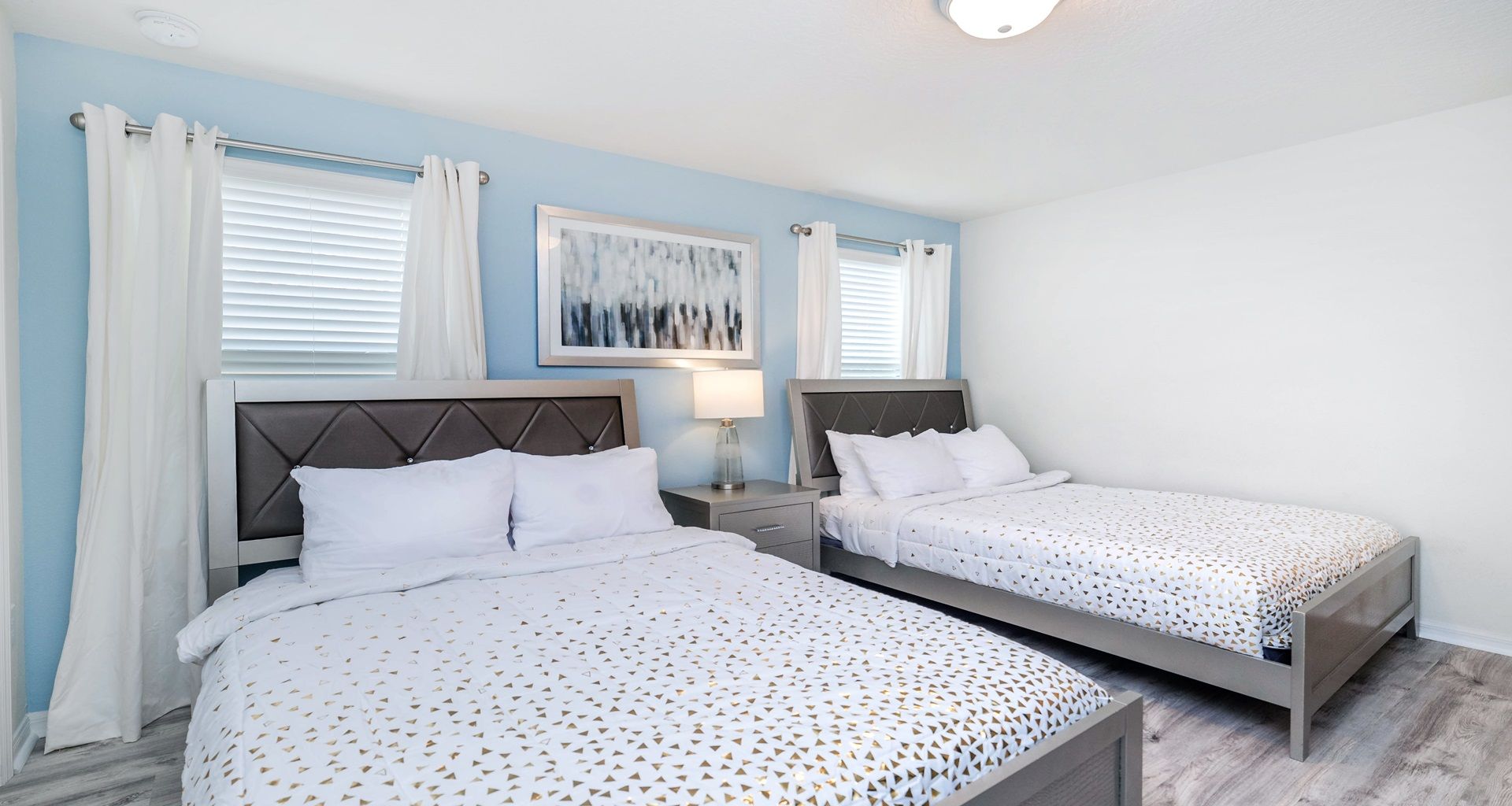 Bright double queen room with modern decor, ideal for friends or family stays.