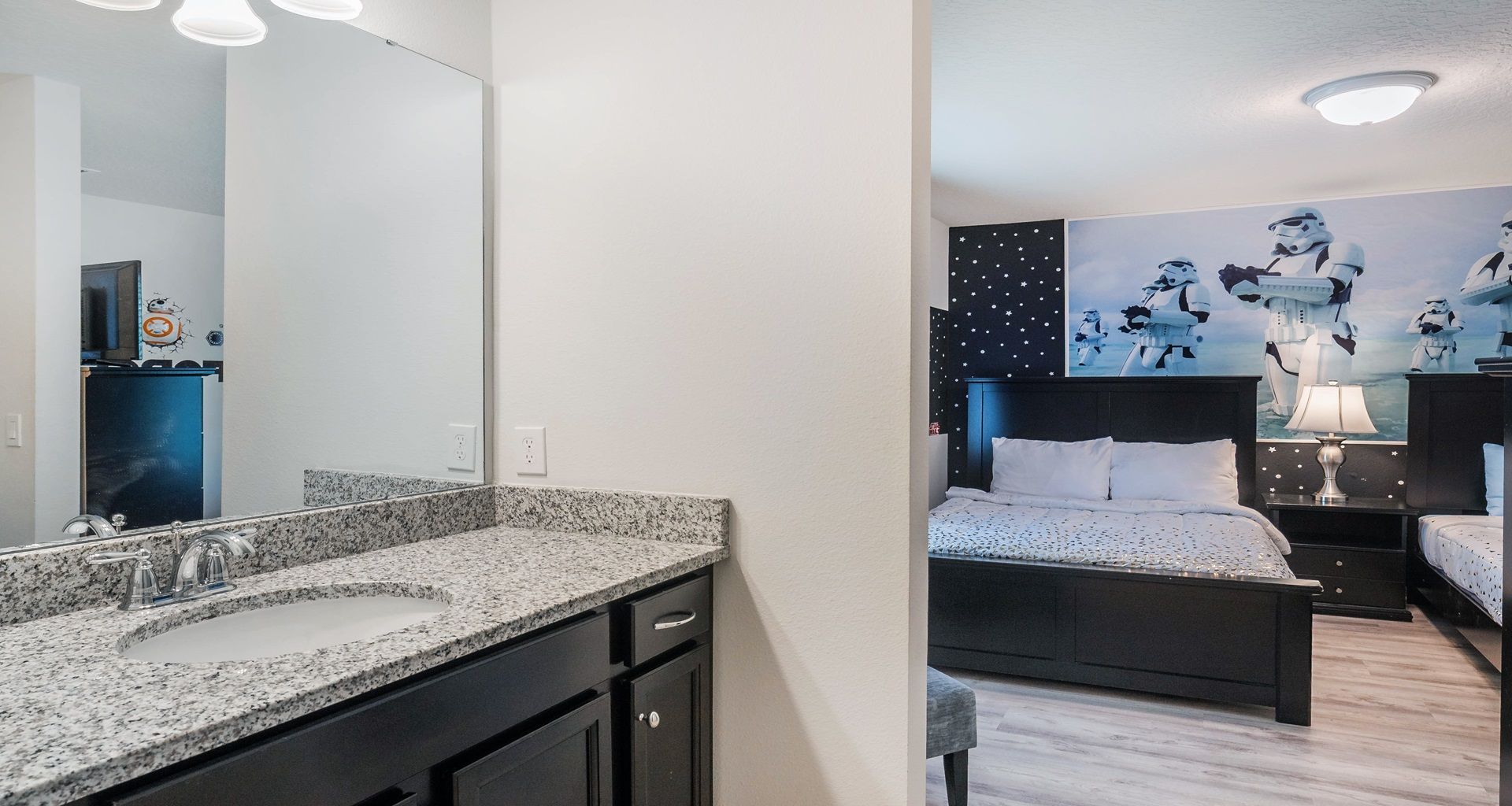 Granite vanity bathroom connected to a Star Wars-themed twin bedroom.