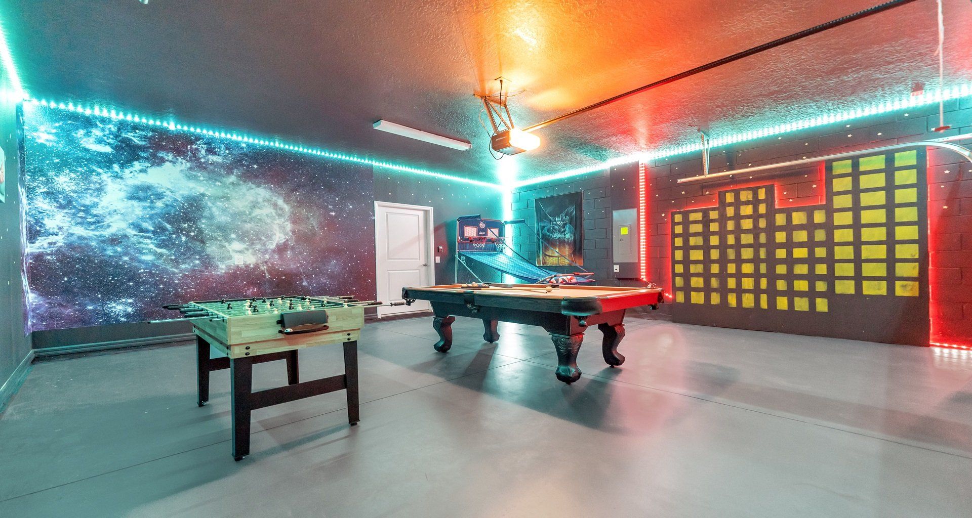 Game room featuring both foosball and pool tables