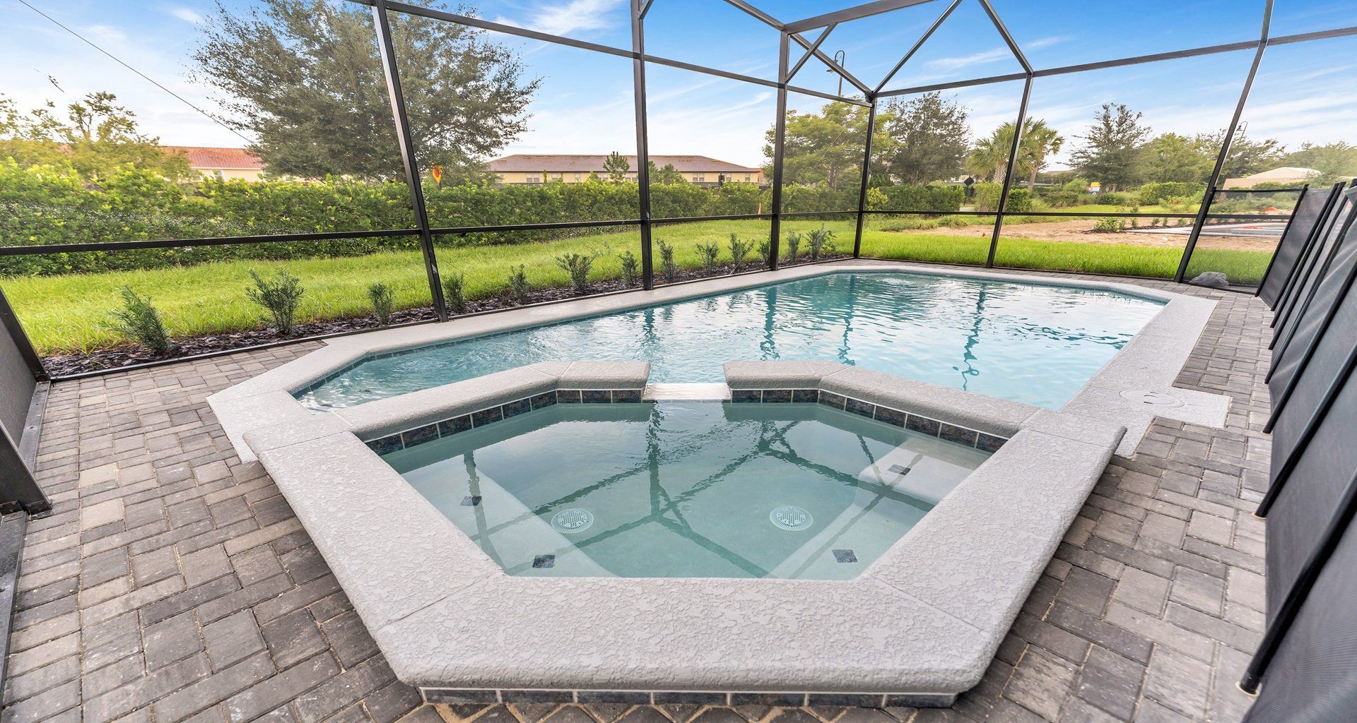 Refreshing outdoor pool, surrounded by vibrant greenery.