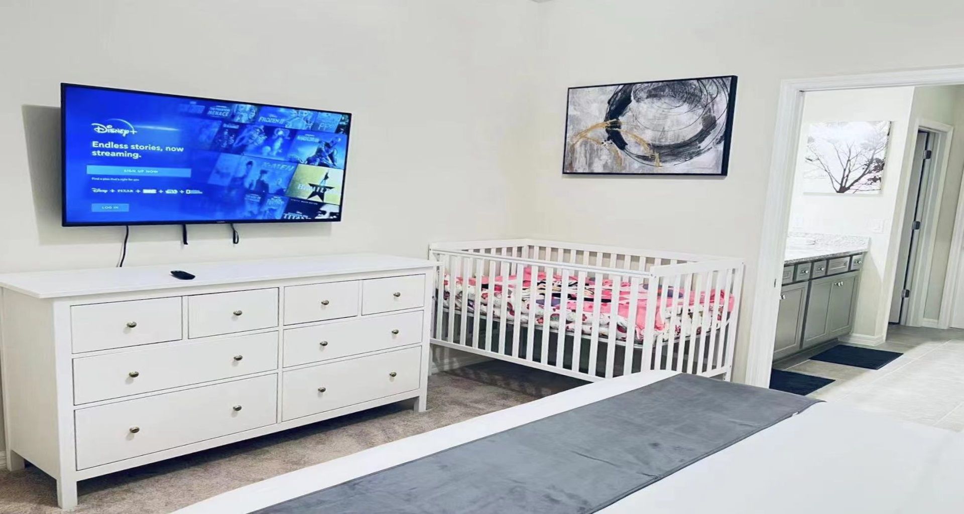 Versatile bedroom with a TV and a crib