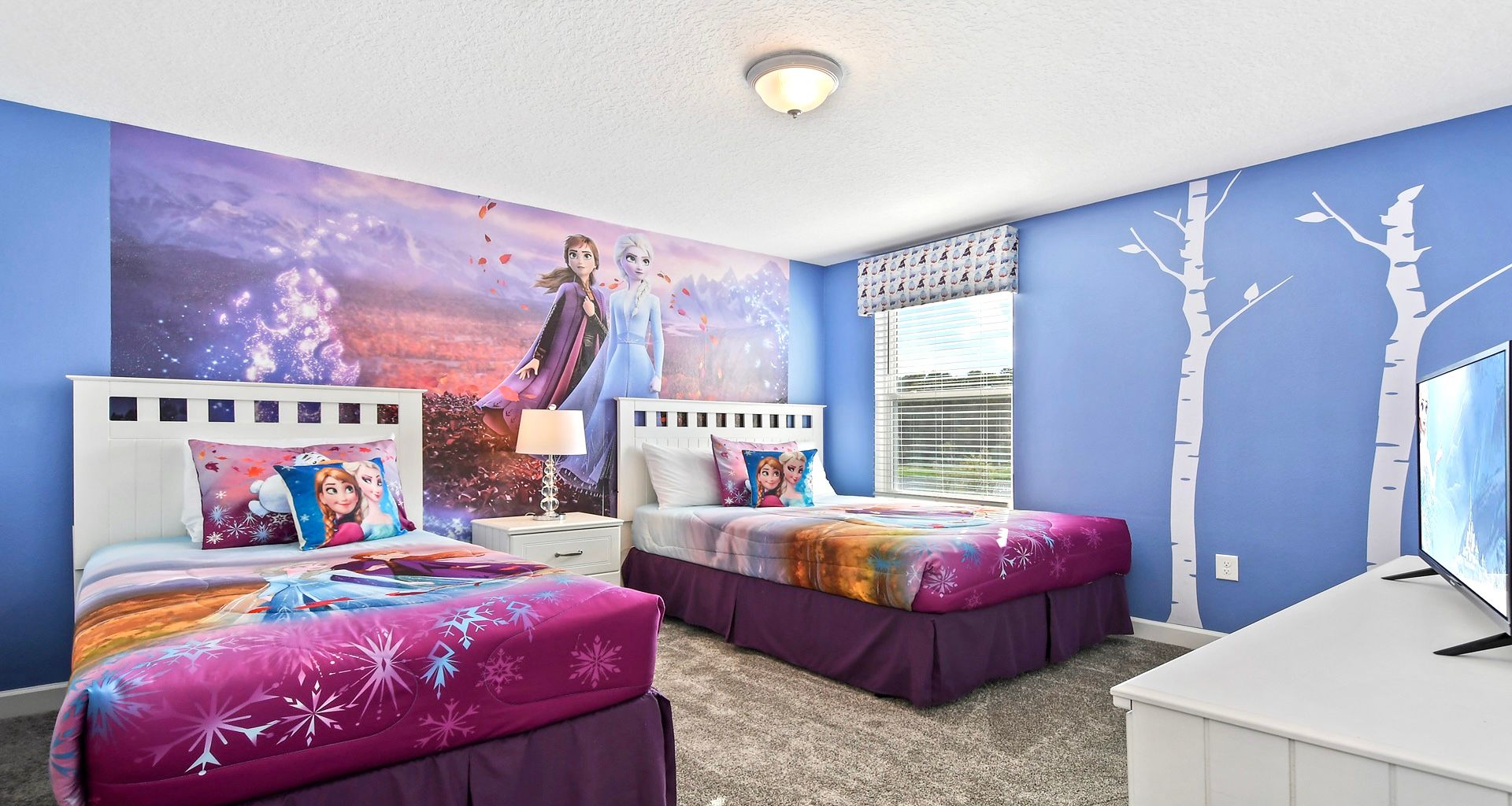 Immerse yourself in a Frozen-themed bedroom, where icy blues and enchanted decor transport the room into the magical world of Elsa and Anna.