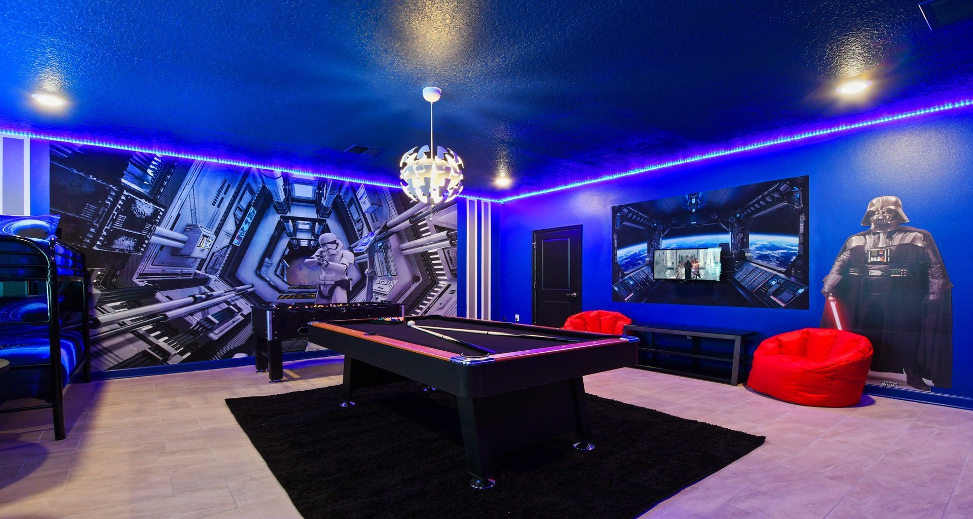 The game room bedroom is impeccably furnished with a Star Wars theme, enhanced by cool lights, creating a unique and captivating ambiance.