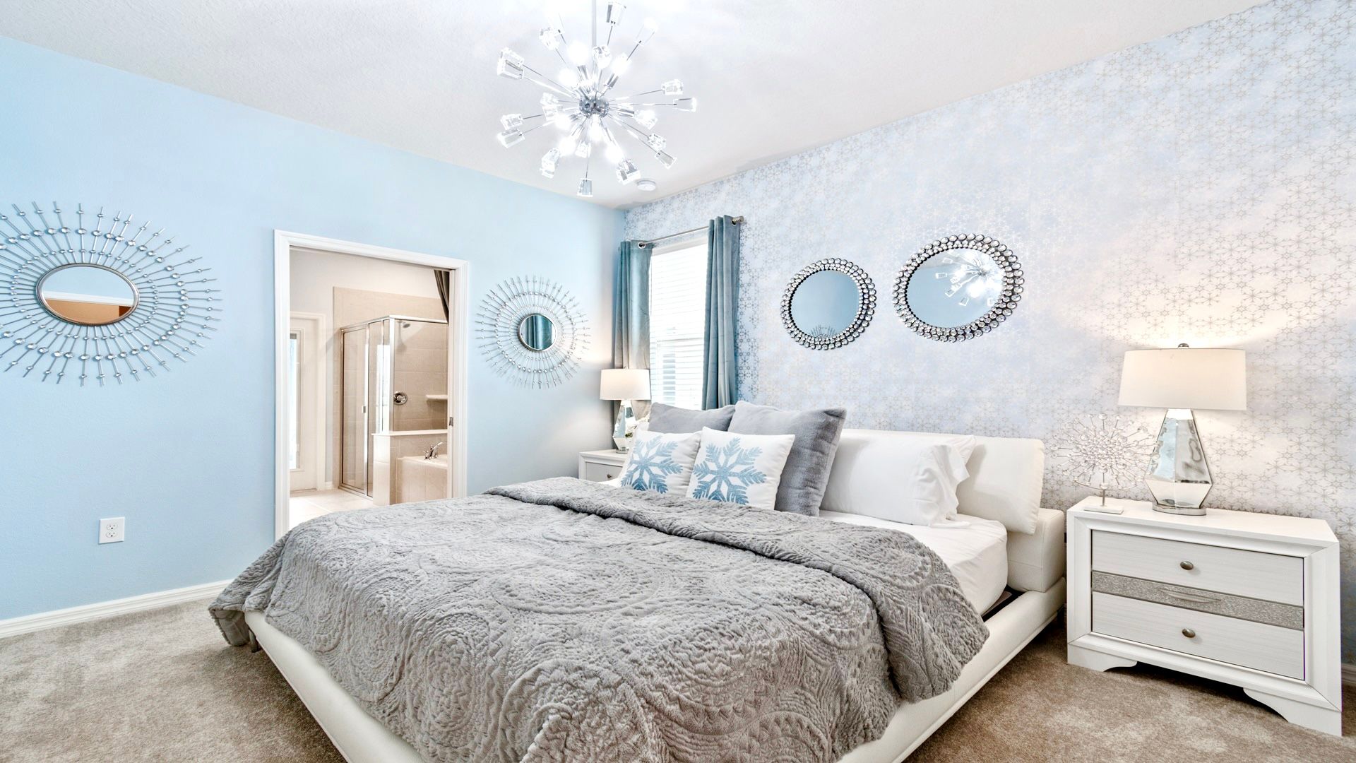 Spacious first floor bedroom with a king-sized bed connecting to a large bathroom.