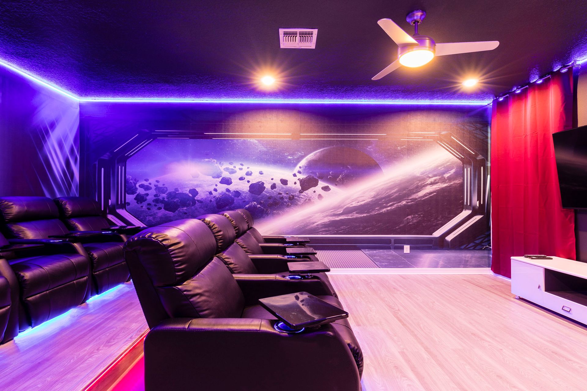 Immersive space-themed home theater with recliners and LED lighting!