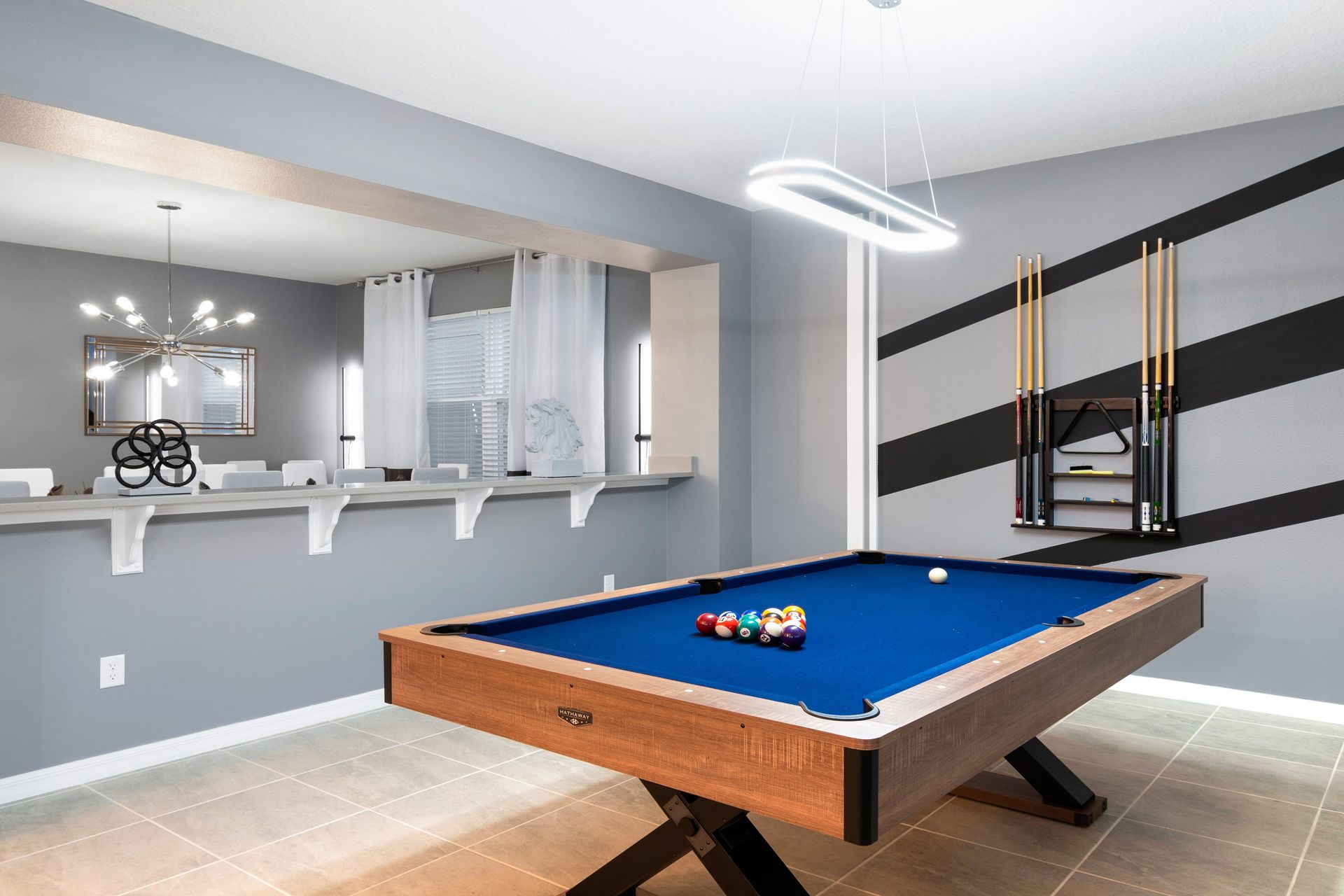 Chic game room with pool table, modern decor, and fun vibes!
