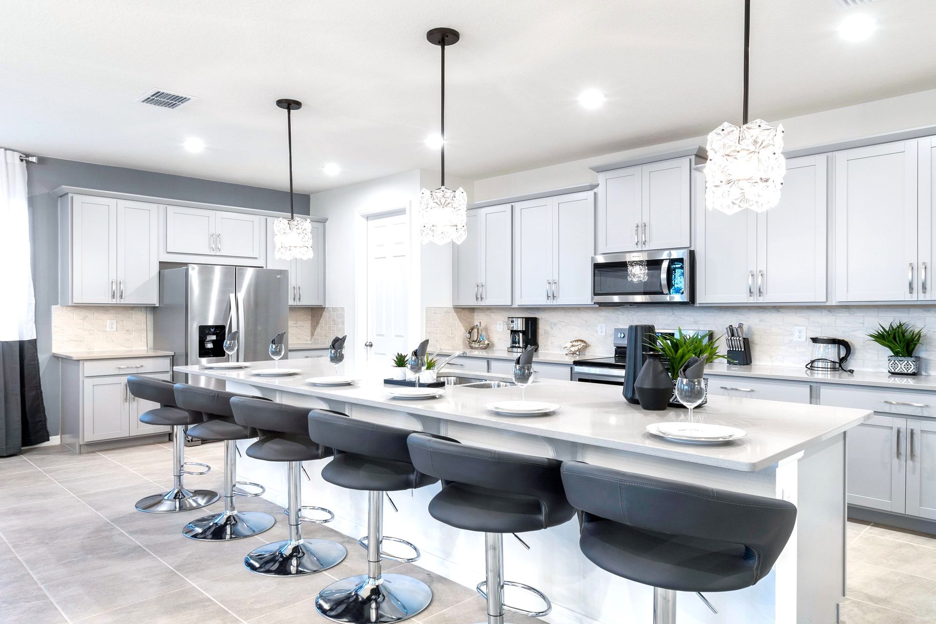 Modern gourmet kitchen with island seating and elegant lighting!