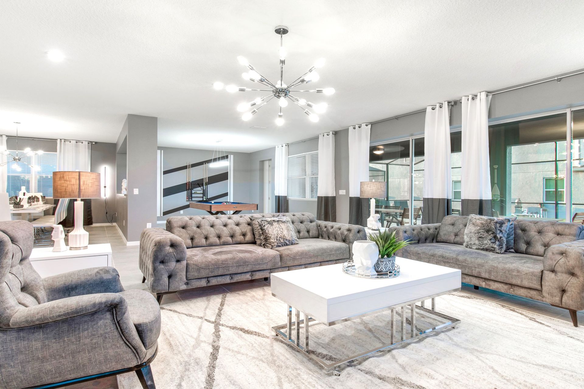 Bright, elegant living space with pool table and modern flair!