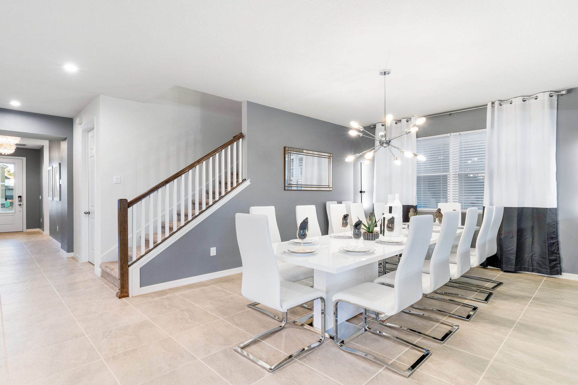 Stylish dining area with seating for 10, modern lighting, and flair!