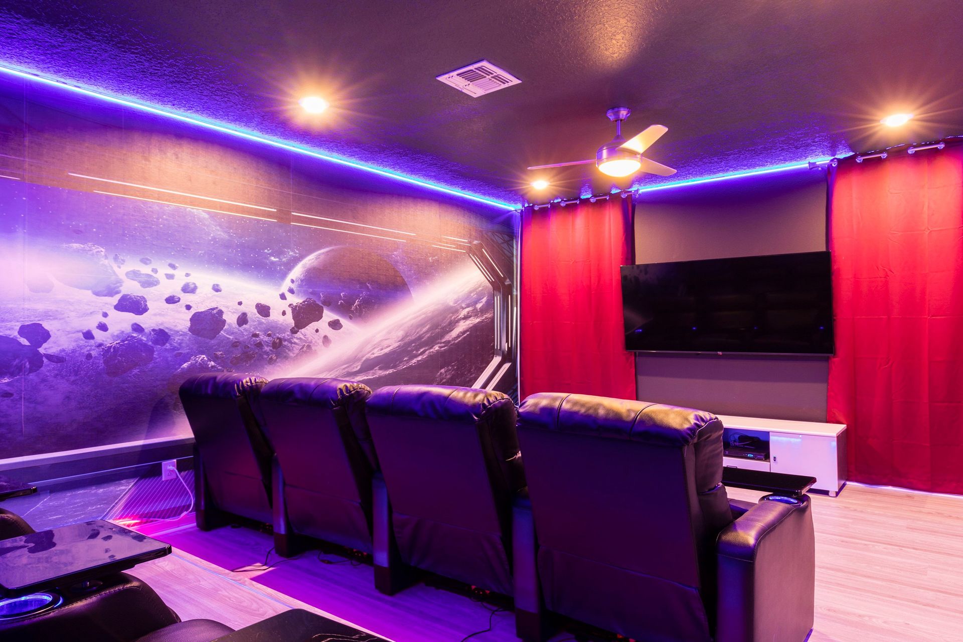 Immersive space-themed home theater with recliners and LED lighting!