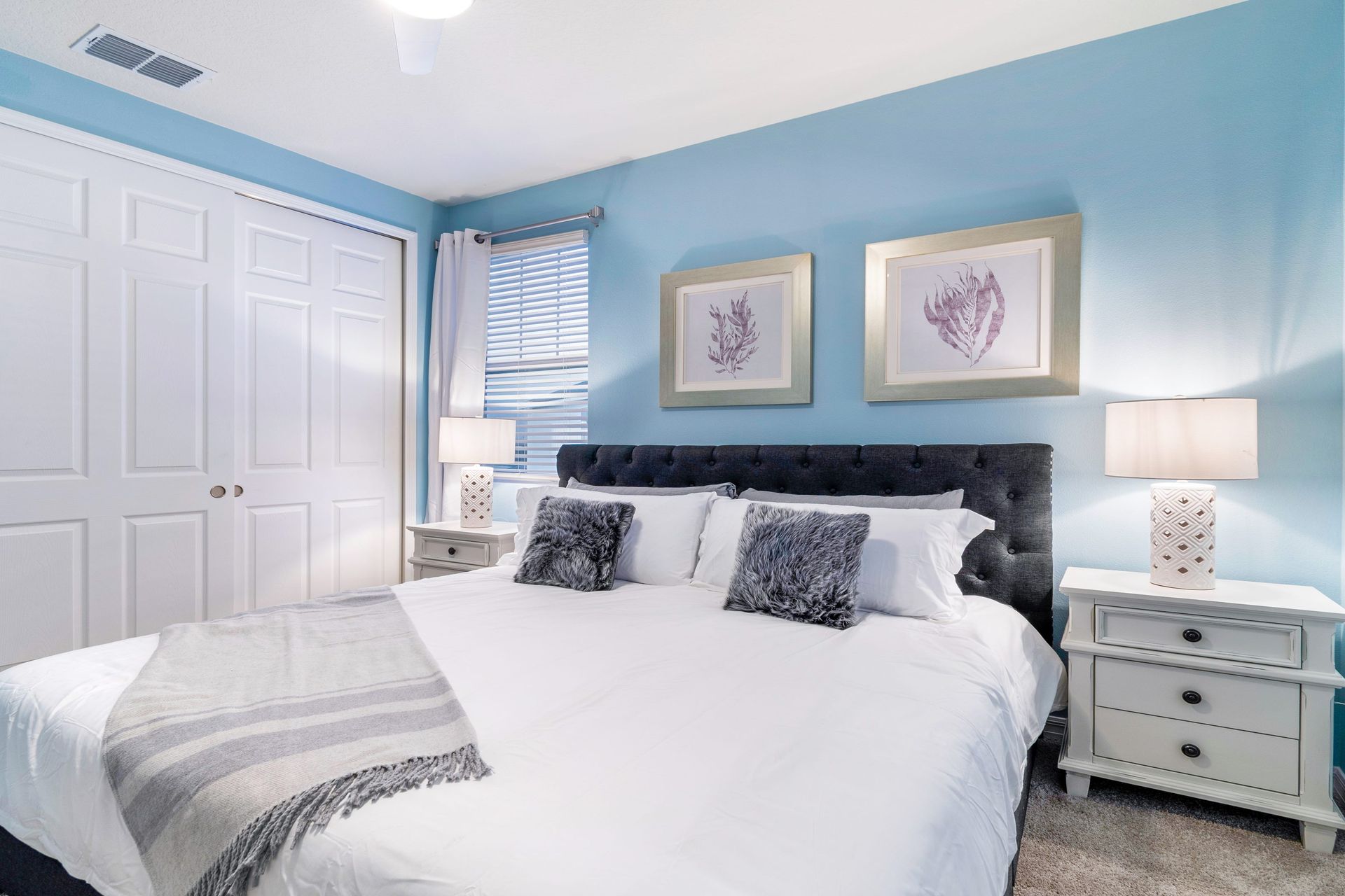 Charming bedroom with coastal accents, plush bedding, and soft lighting!