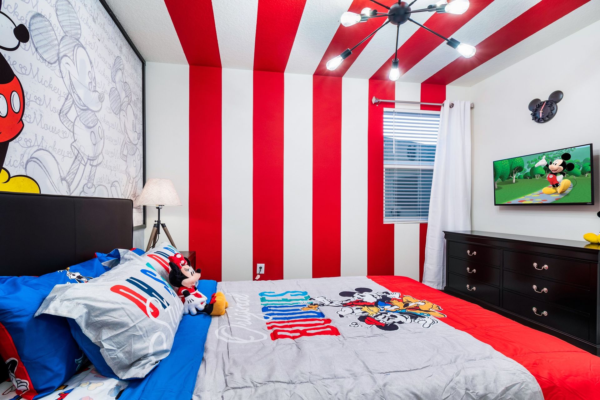 Cheerful Mickey Mouse-themed bedroom with bold stripes and fun decor!