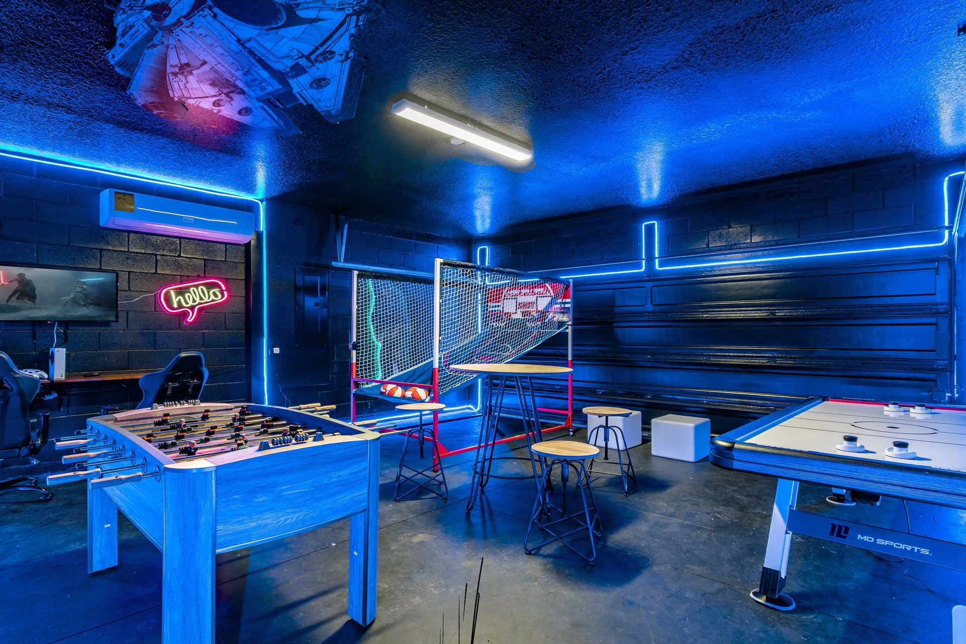 Ultimate neon game room with foosball, air hockey, and gaming setup!