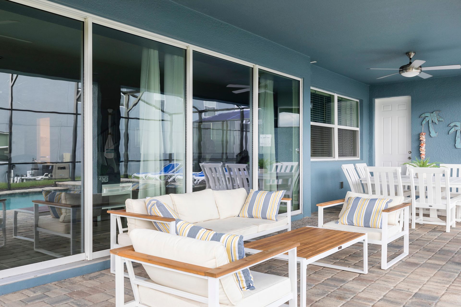 Relaxing screened patio with cozy seating, swing chair, and serene views!