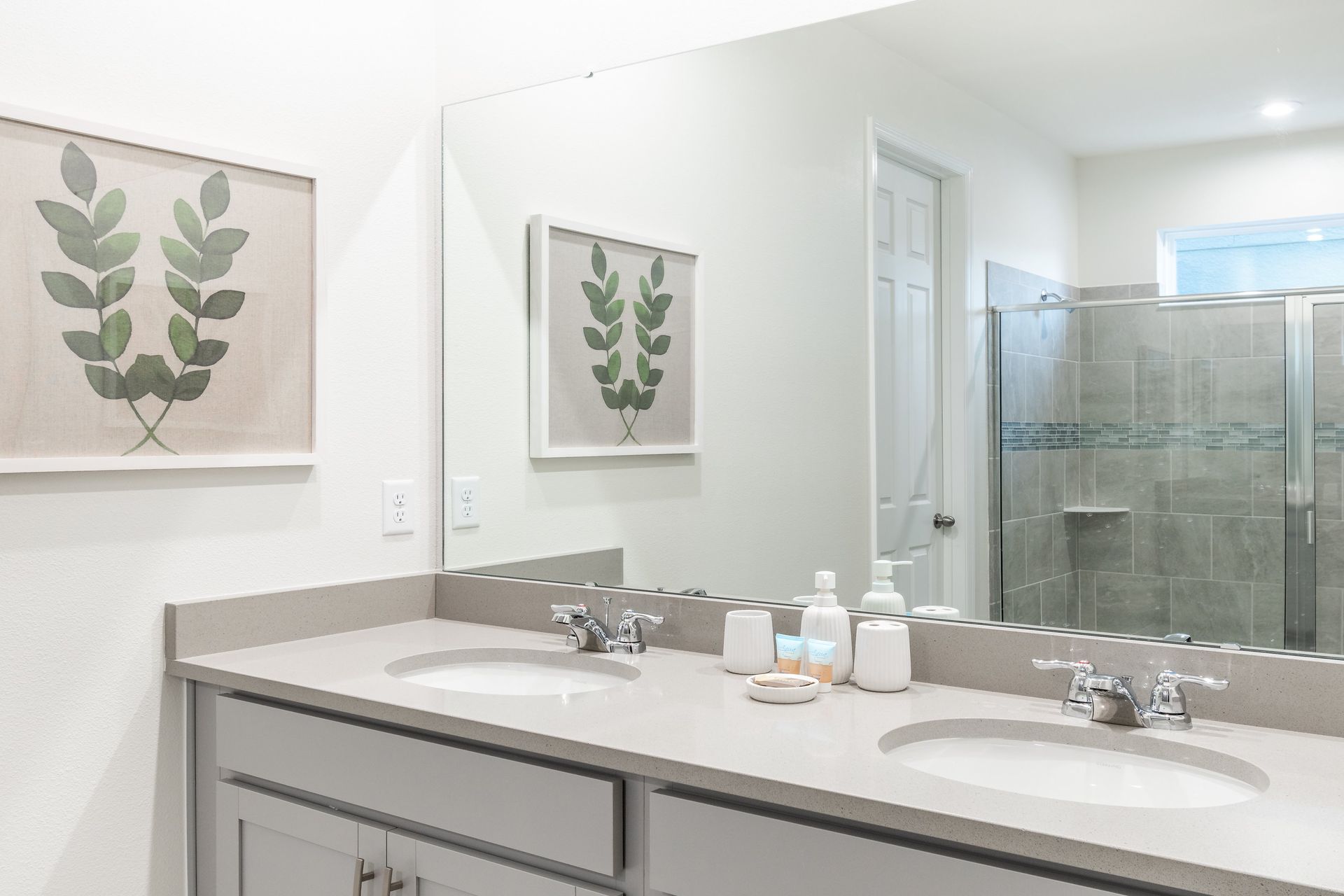 Modern bathroom with double vanity, spacious shower, and calming decor!
