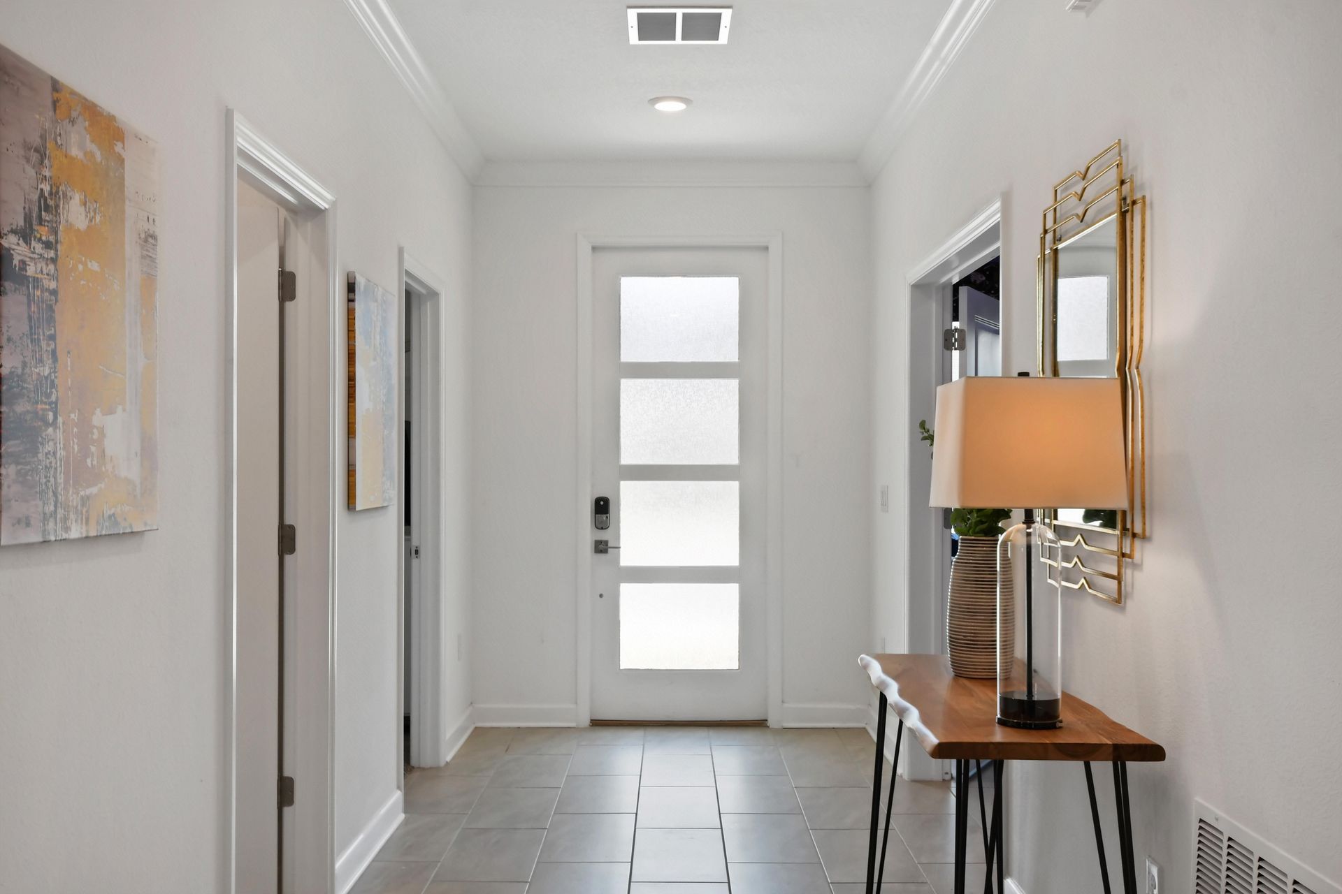 Bright and modern entryway with elegant decor, warm lighting, and a stylish touch.