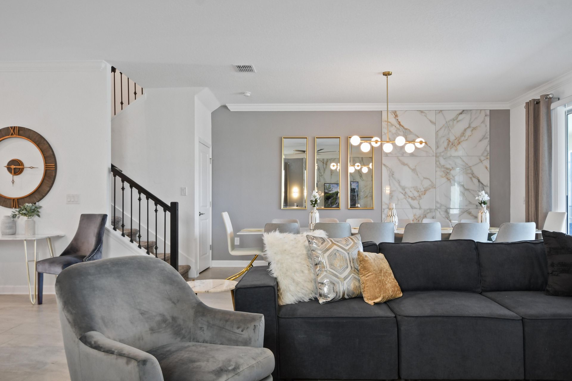 Stylish open-concept living space with modern decor, cozy seating, and a sleek kitchen.