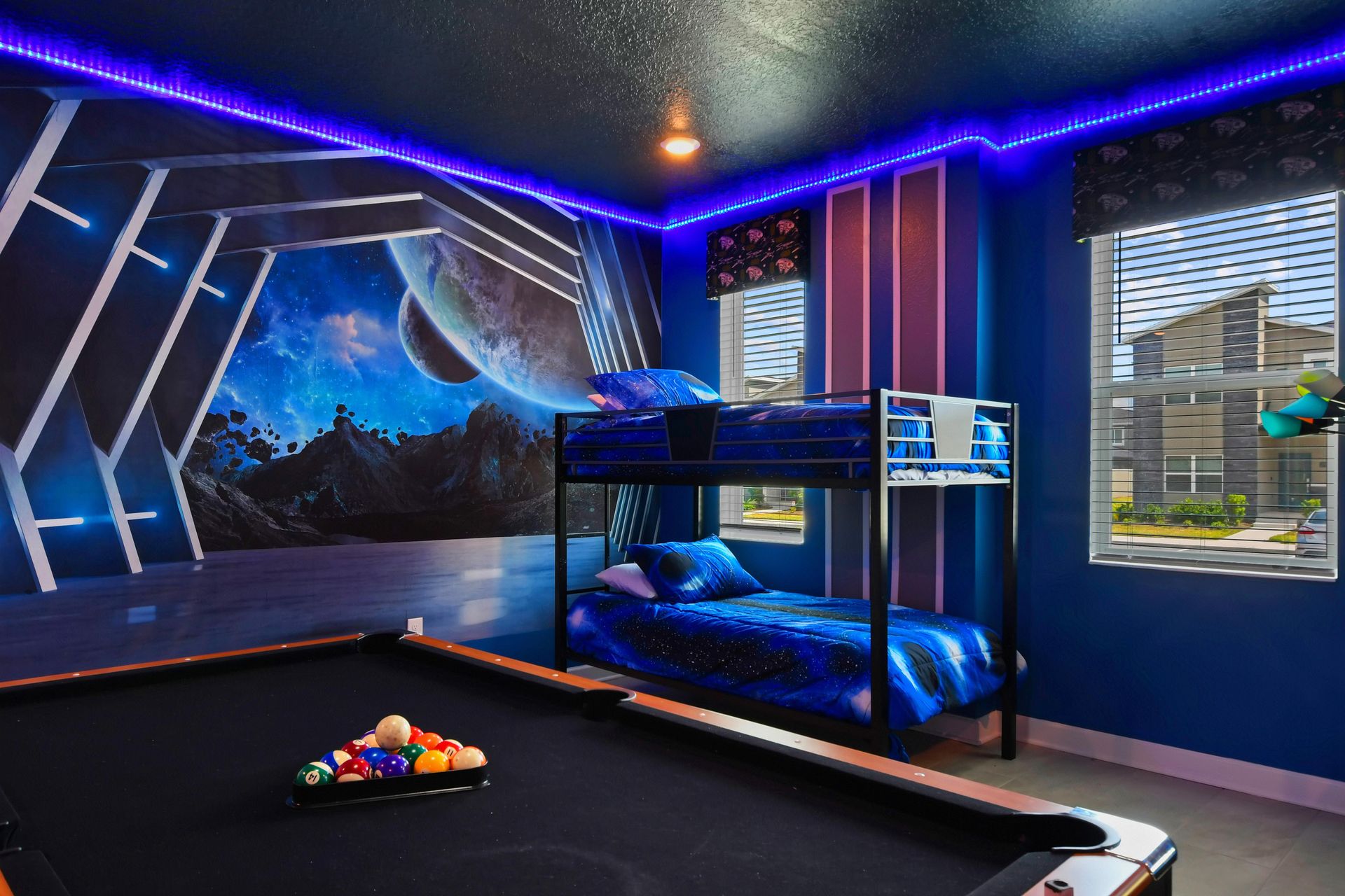 Epic space-themed game room with bunk beds, a pool table, and glowing LED lights.